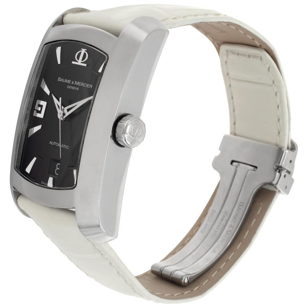 Baume & Mercier Hampton in stainless steel on a white leather strap with deployant buckle. Auto w/ sweep seconds and date. 46 mm length (lug to lug) by 30 mm width case size. Ref 65447. Fine Pre-owned Baume & Mercier Watch. Certified preowned
