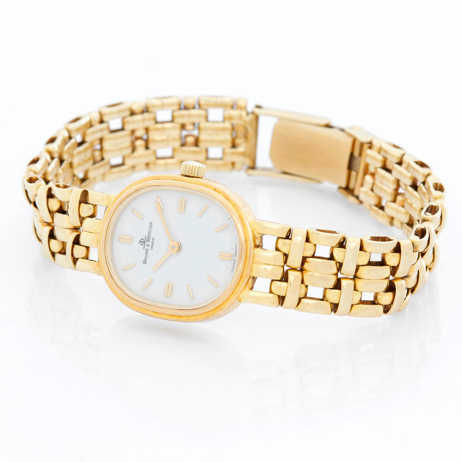 Baume & Mercier Ladies Classic Watch  - Quartz . 18K  Yellow gold ( 17 mm ) . Matte white dial with stick hour markers . 14K Yellow gold bracelet. Will fit up to a 6 inch wrist . Pre-owned with custom box .