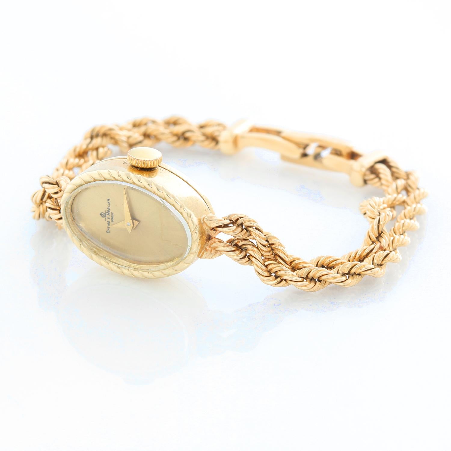 Baume & Mercier Ladies Classic Watch - Quartz. 14K  Yellow gold ( 14 x 20  mm ). Champagne dial. 14K Yellow double rope link bracelet; will fit up to a 6 inch wrist . Pre-owned with Baume & Mercier  box. 