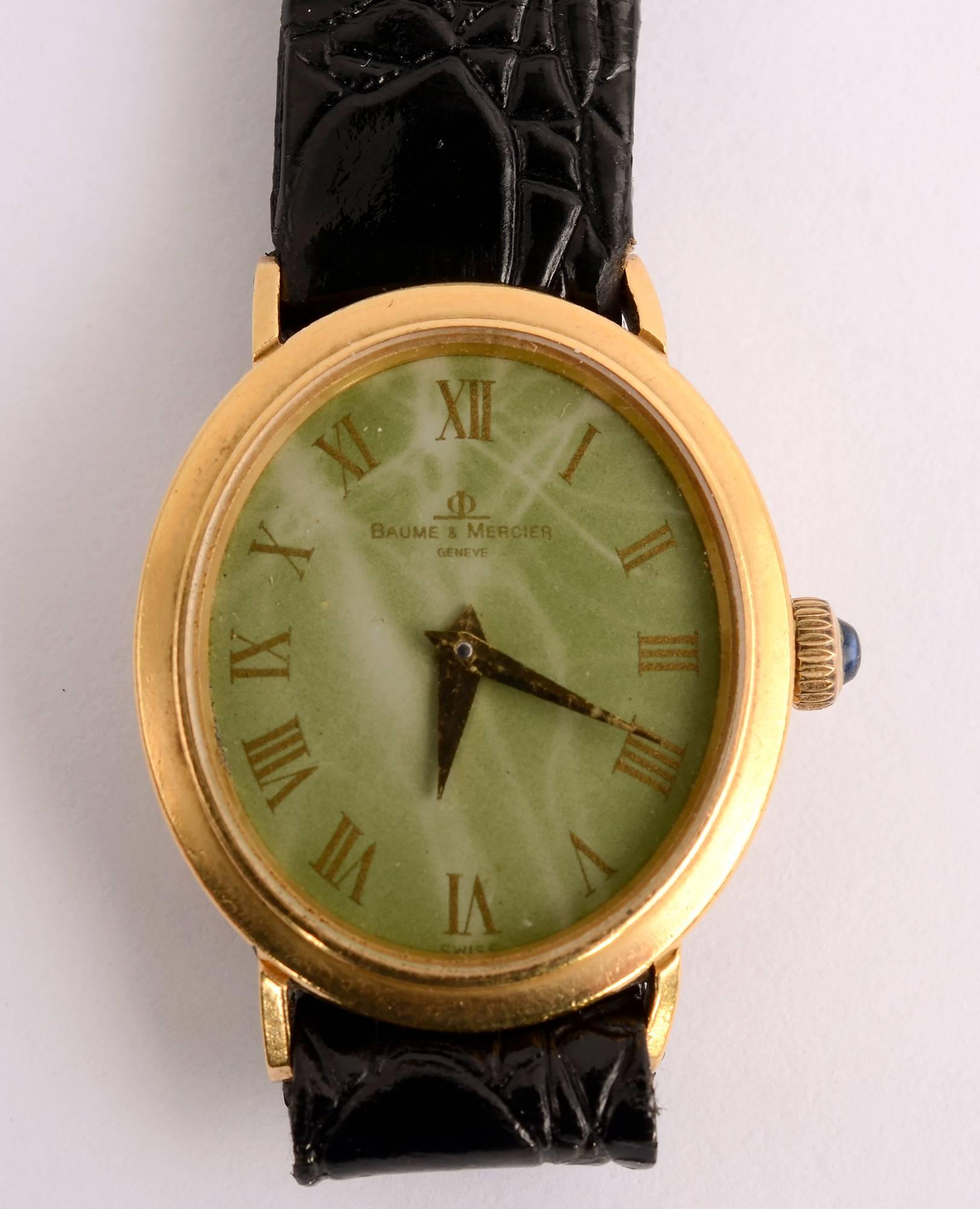 Baume & Mercier ladies gold watch with Roman numerals. The oval face is painted to simulate green agate.  It measures 13/16