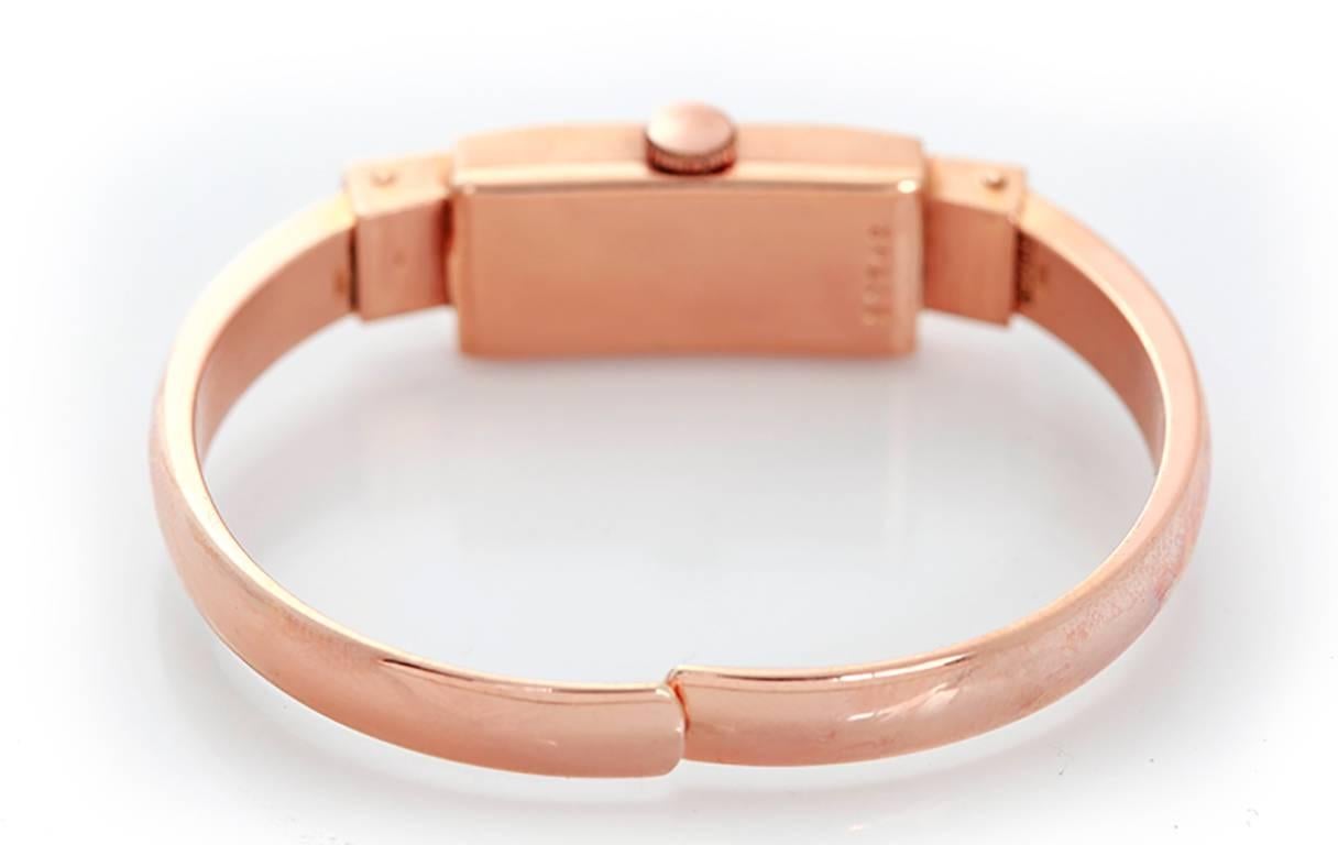 Manual winding. 18k rose Art Deco style gold case (11mm x 35mm). Silvered dial with Arabic numerals. 18k rose gold spring hinged bracelet (will fit up to apx. 5-3/4 inch wrist). Pre-owned with custom box.