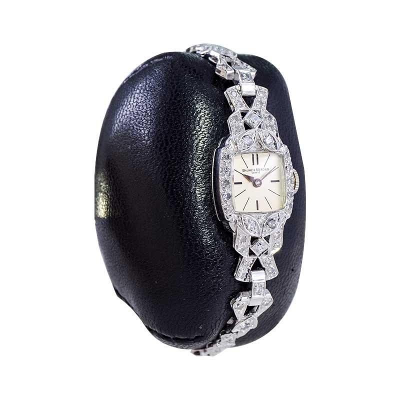 FACTORY / HOUSE: Baume Mercier
STYLE / REFERENCE: Cushion Shape Dress Watch
METAL / MATERIAL: Platinum
CIRCA / YEAR: 1940's
DIMENSIONS / SIZE: Length 12mm X Width 12mm
MOVEMENT / CALIBER: Manual Winding / 17 Jewels 
DIAL / HANDS: Silvered with Baton