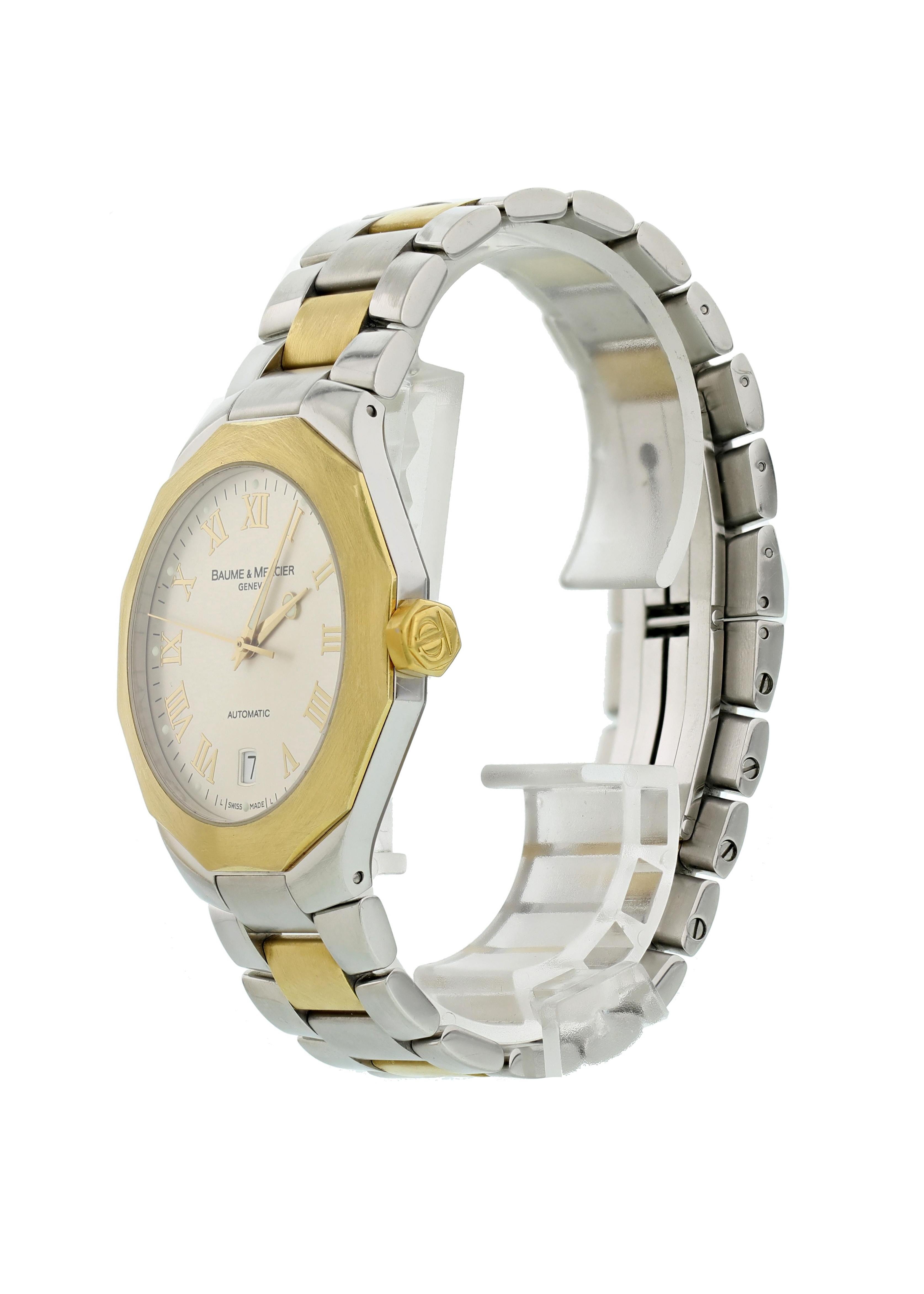 Baume & Mercier Riviera 65583 Mens Watch. 38mm Stainless steel case. 18K yellow gold dodecagon shaped fixed bezel. Silver dial with gold-tone hands and Roman numeral hour markers. Minute marker on the outer dial. Date display at the 6 o'clock