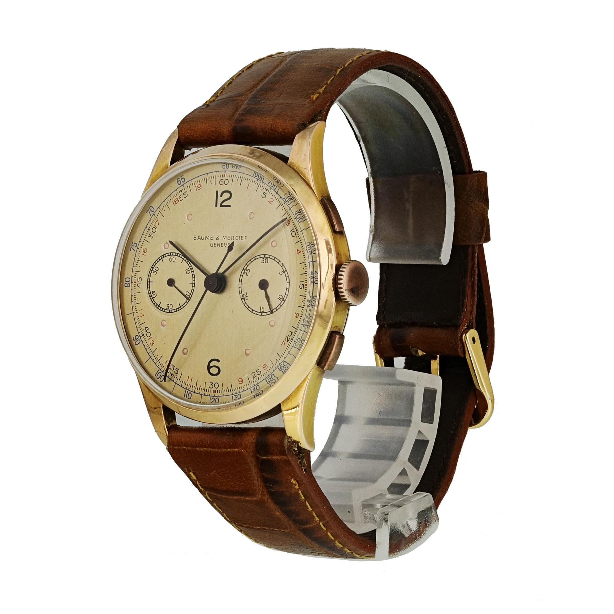 Baume & Mercier Vintage Chronograph Mens Watch.
37mm 18k Rose Gold case. 
Rose Gold Stationary bezel. 
Champagne dial with black hands and Arabic numeral hour markers. 
Minute markers on the outer dial. 
Leather Strap with Buckle. 
Will fit up to a
