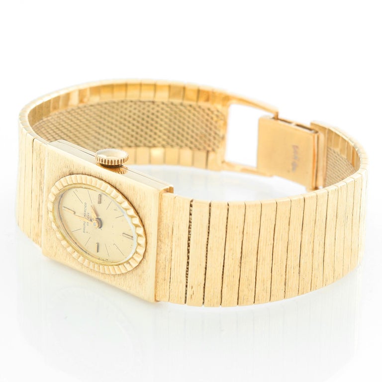 Baume & Mercier Vintage Yellow Gold Ladies Watch - Manual winding . 14K Yellow gold with fluted bezel ( 19 x 25 mm ) . Champagne dial with stick hour markers . 14K textured link bracelet; will fit up to a 6 3/4 inch wrist . Pre-owned with Baume &