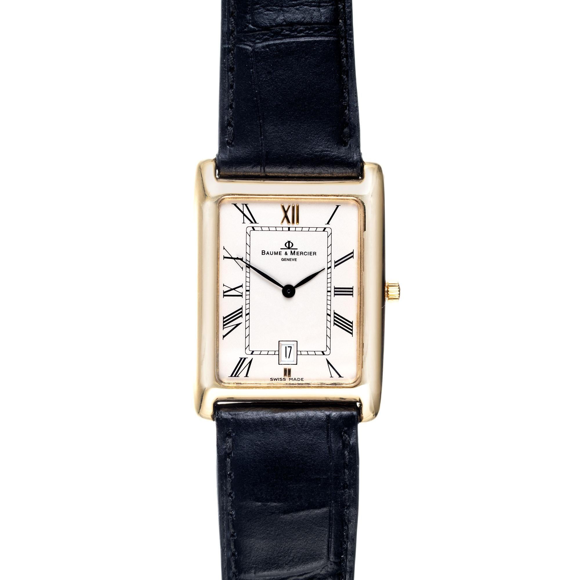Baume & Mercier 18k yellow gold tank style mens wristwatch. Quartz movement, date and roman numerals.

Length: 35.19mm
Width: 25.57mm
Band width at case: 19mm
Case thickness: 5.19mm
Band: Genuine black leather. New (original buckle)
Crystal: