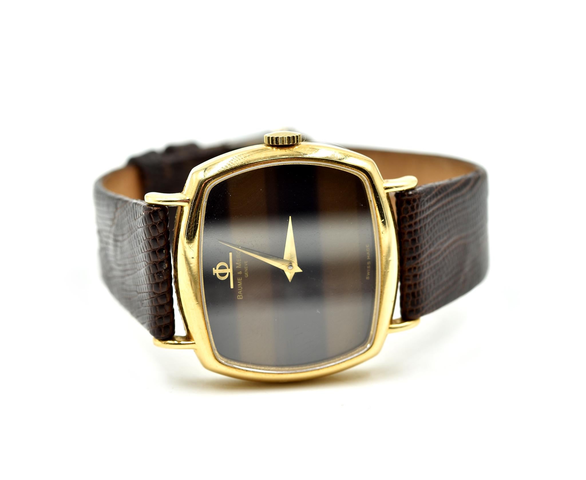 Movement: manual wind
Function: hours, minutes
Case: 32mm 18k yellow gold case with sapphire crystal, pull/push winding crown
Band: brown lizard strap with gold-tone buckle
Dial: tiger eye dial with gold hands 
Reference: M0A01012
Serial #: