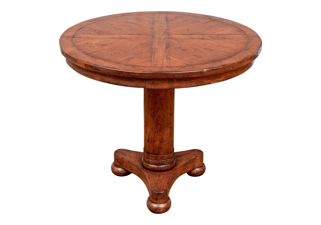 Fine Bausman attributed craftsmanship in a fine deep toned Center Table which may be used effectively as a Games or small Dining Table. The round banded top made in quadrants. The column form support with turned lower band mounted on a curved tripod