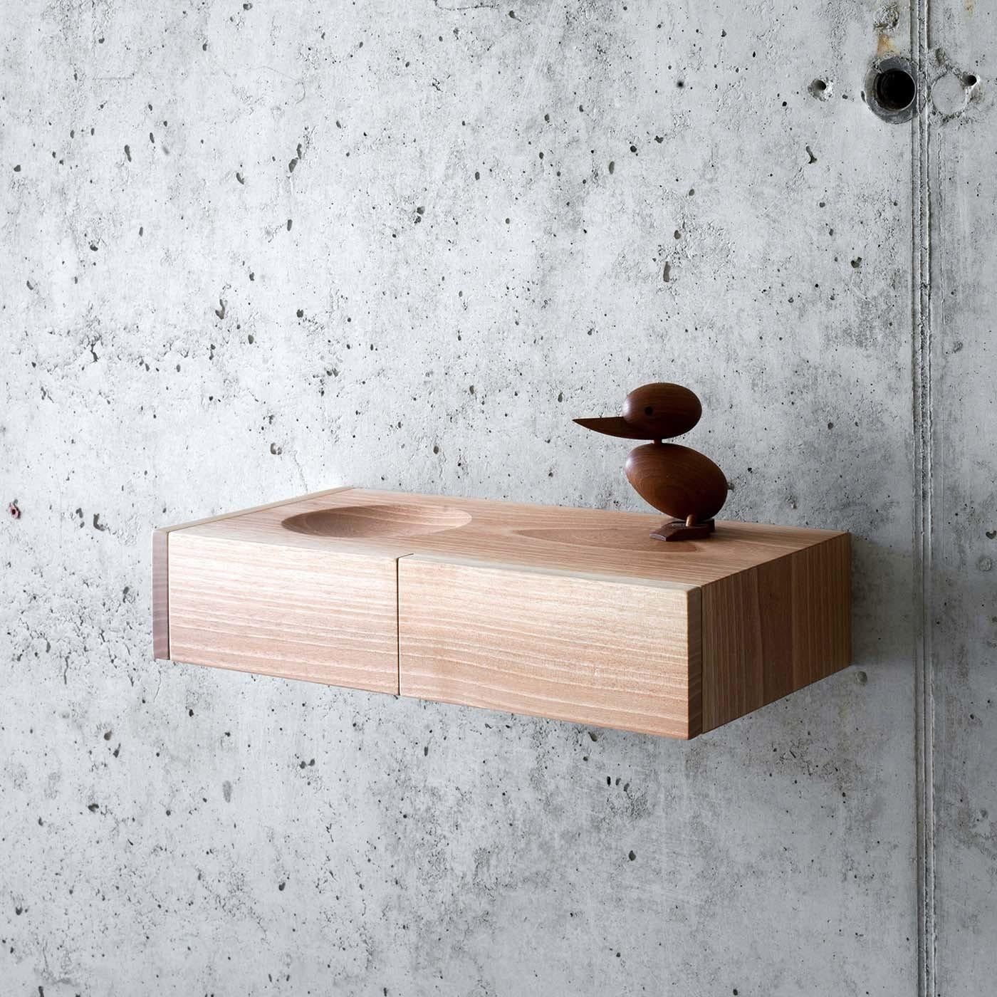 Designed by Pasquini Tranfa Architects, this elegant piece is the small version of the BÃ uti Shelf, a versatile and sophisticated tray to hang on a wall in an entryway, bedroom, or powder room. Its unique shape was crafted entirely of solid walnut