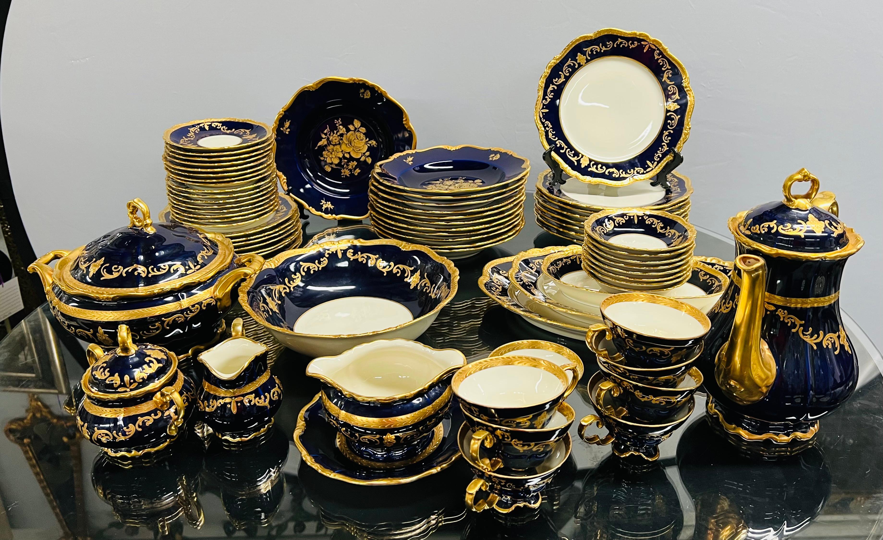 A set of 69 pieces Waldershof Echt Bavaria 22 K cobalt blue China set made in Germany. The beautiful set features fine leaves and floral design and curvy rim shape in 22 K gold. The art nouveau design inspired China set includes 69 pieces including