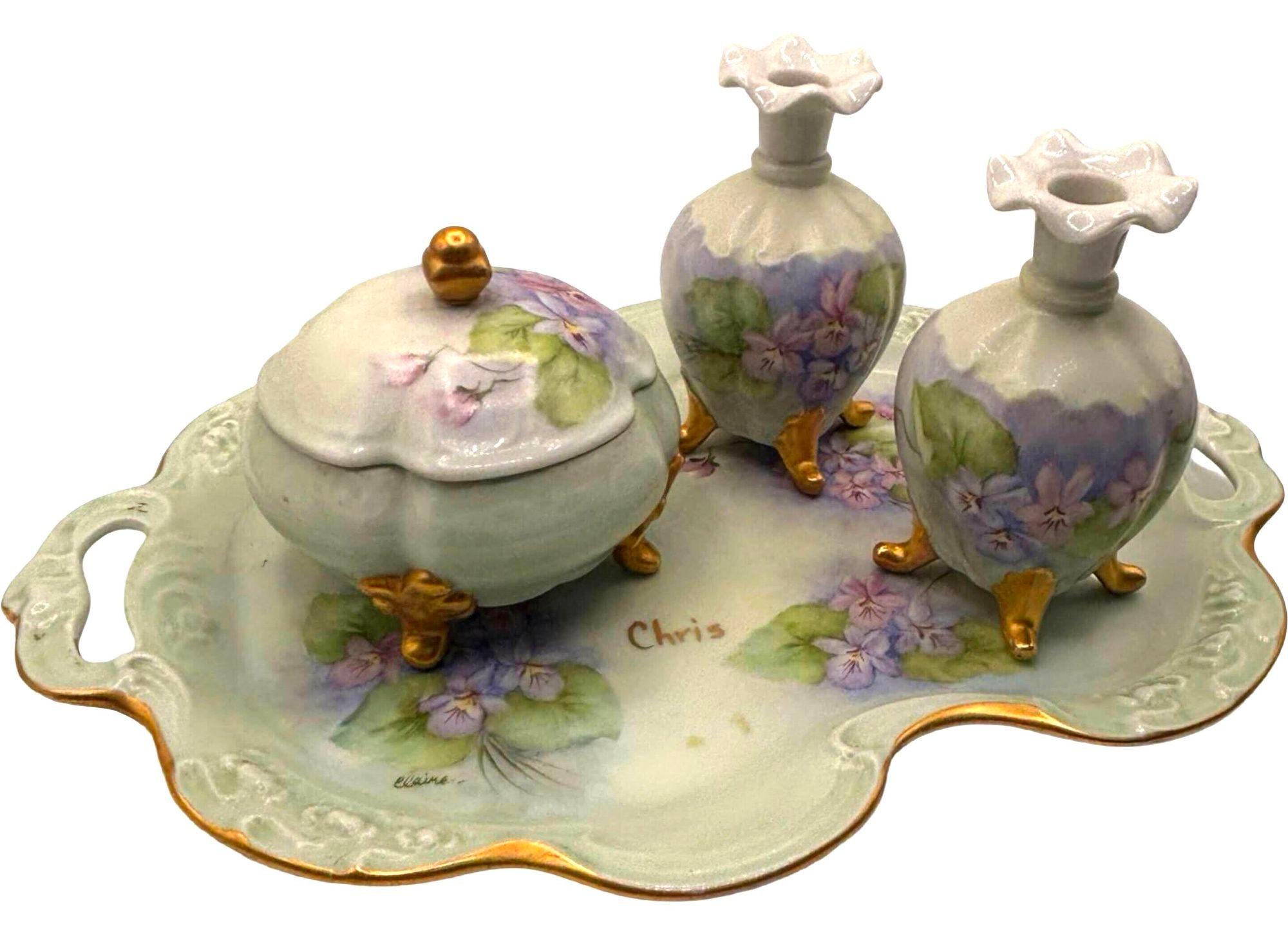 Beautiful early 20th century Bavarian Art Nouveau Vanity Set, each designed hand-painted with timeless elegance and delicate artistry. The set features a tray, 2 perfume bottles, and a powder jar with a lid, each with refined hand-painted floral