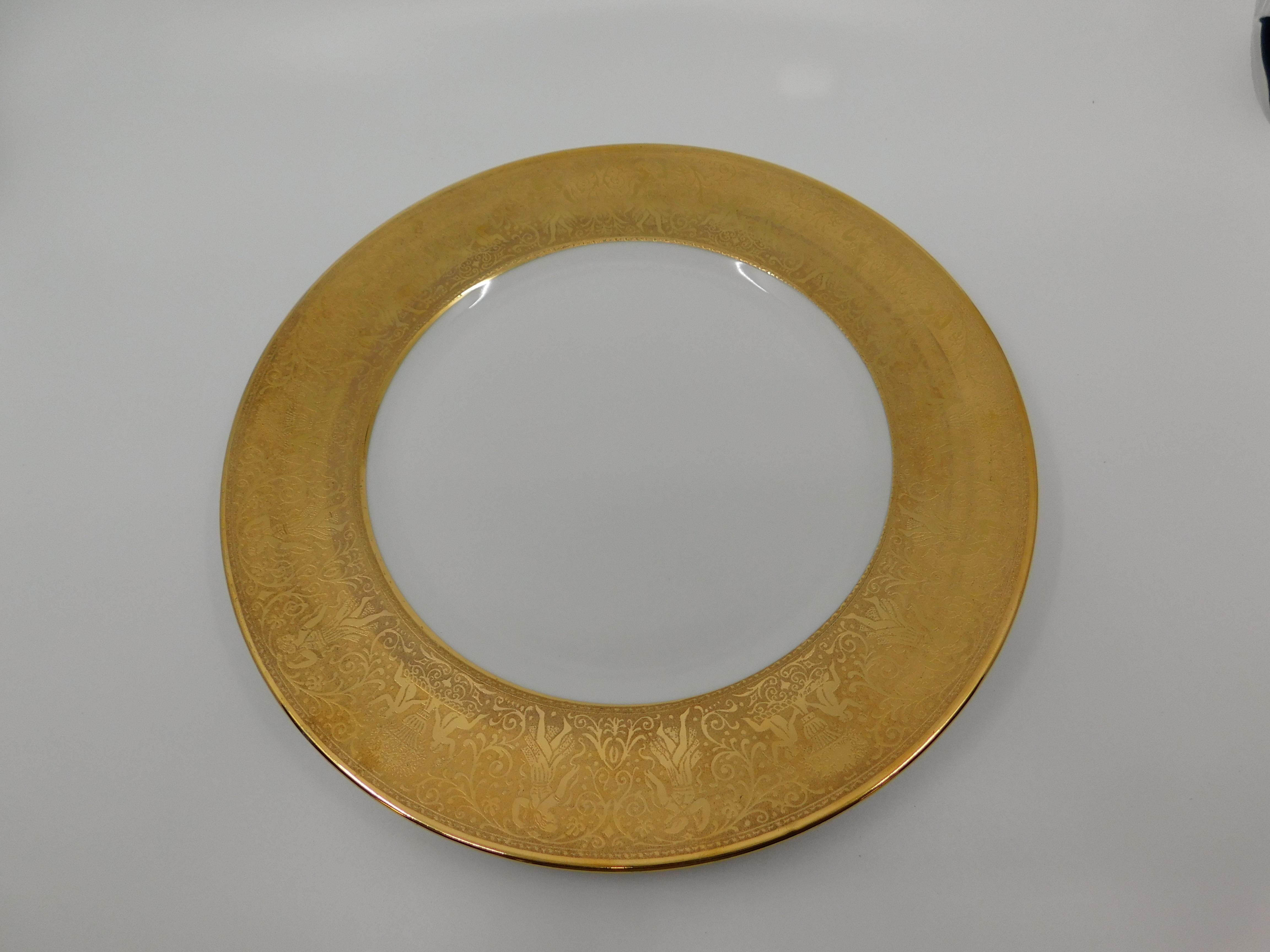 Set of twelve Bavarian Heinrich & Co. gold etched dinner plates. The gilt borders are etched with urns, flowers and scrolls. Marked Heinrich & Co. Bavaria on the underside of each plate, circa 1920. Measures: 10 3/4