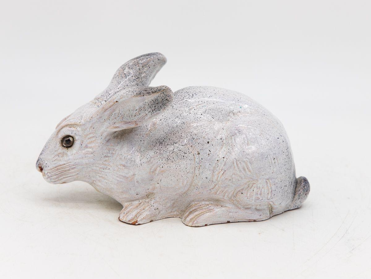 Crafted in the 1890s in France, this Bavent Ceramic Hare model is a testament to the artistry of its time. Fashioned from terracotta majolica and adorned with a cool white glaze, the hare's lifelike features are accentuated by delicate black