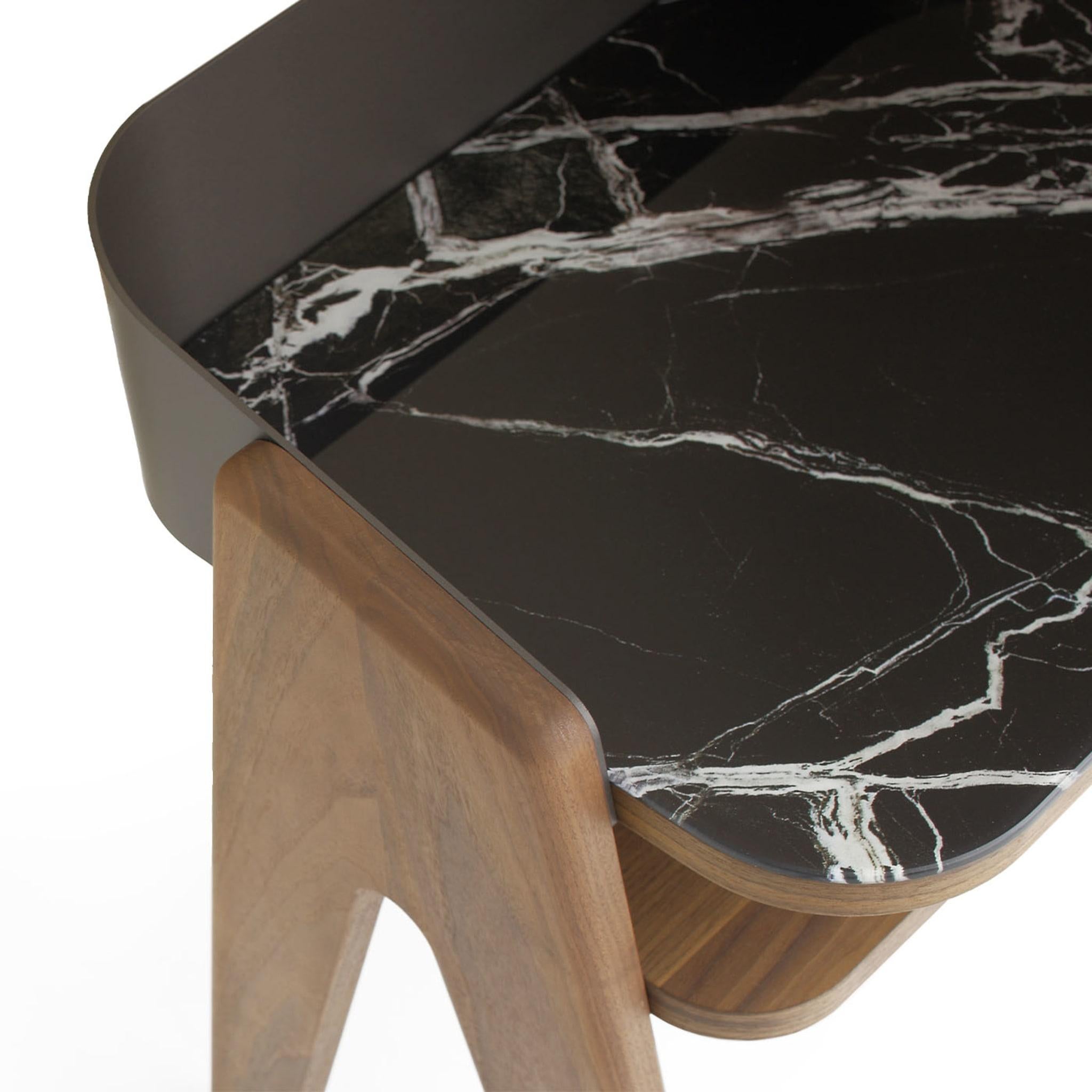 Ideally combined with its desk counterpart for an exclusive cohesive look, this nightstand seduces with its walnut grain and intriguing marbled traceries. The enveloping calendered metal shell - sustained by V-shaped solid Canaletto walnut legs -