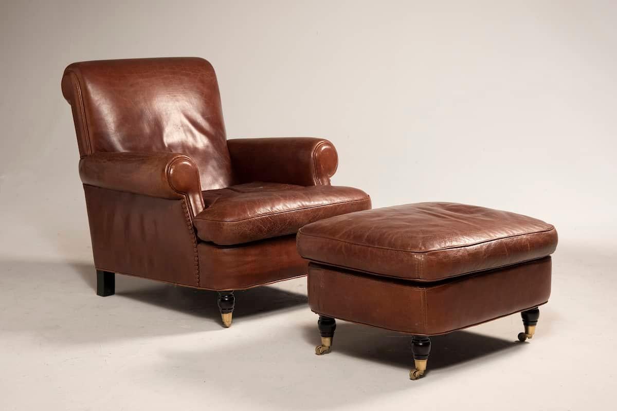 Elegant armchair and ottoman set by Baxter, upholstered in beautifully aged leather that retains its original vintage charm and is in excellent condition. 
As always, Baxter stands for quality, refinement, and—in the case of this set—exceptional