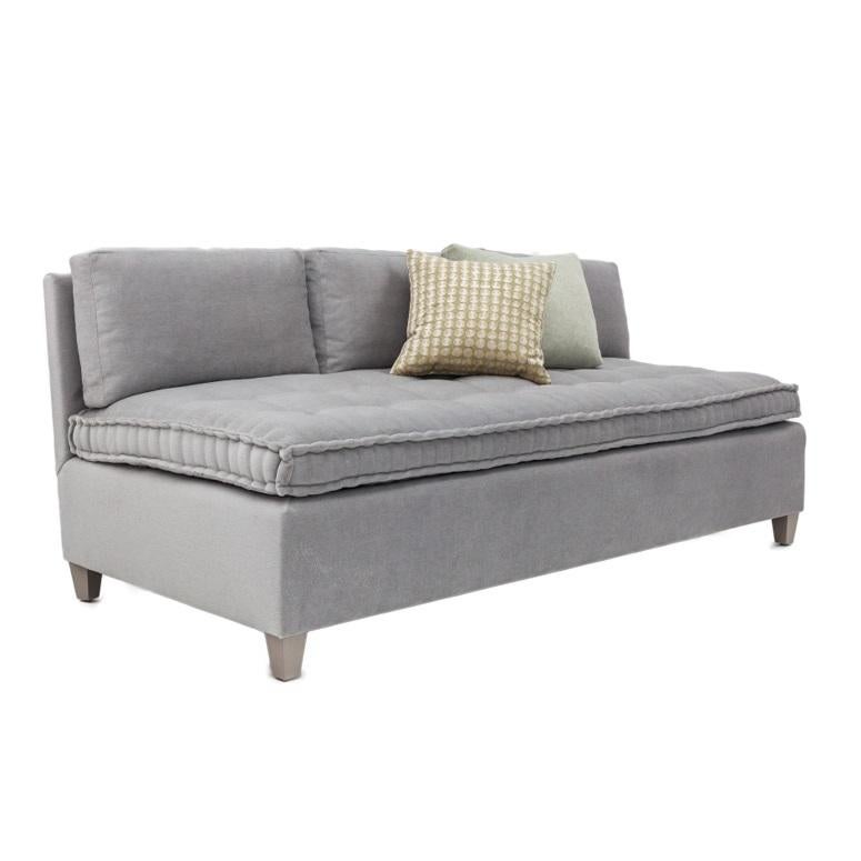 Armless sofa featuring a French Mattress style seat cushion with button tufting. The Baxter Sofa frame is constructed using solid maple wood with 50 / 50 down feather filled cushions. Four finishes available for sofa legs. Available in four cotton