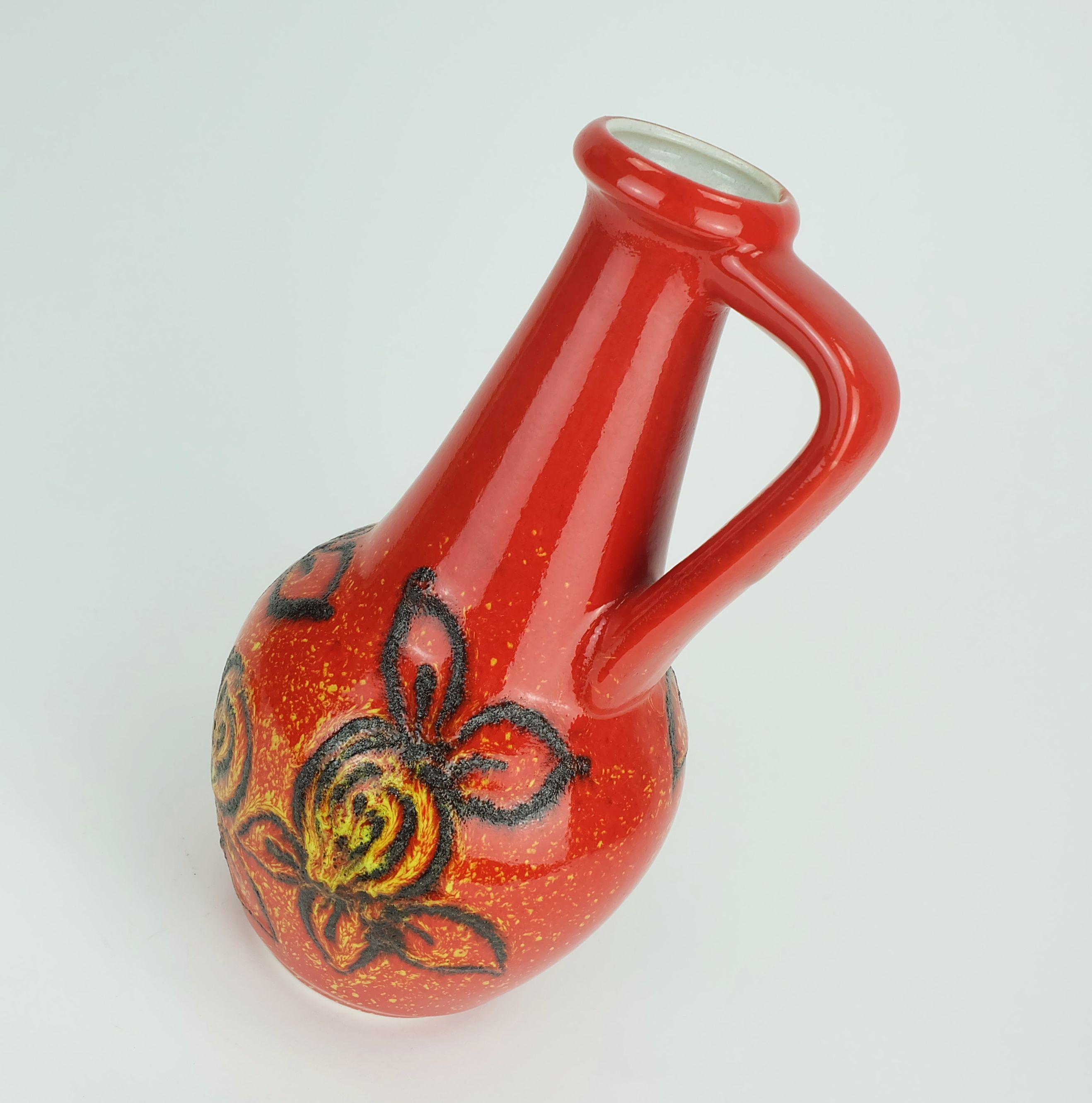 A fantastic vintage West German vase made by Bay Keramik in the 1960's to early 1970's. Intense red and yellow shiny glaze combined with black fat lava leaf pattern. Model number 67 30.

Dimensions in cm:
Height 31 cm, width 16 cm.

Dimensions in