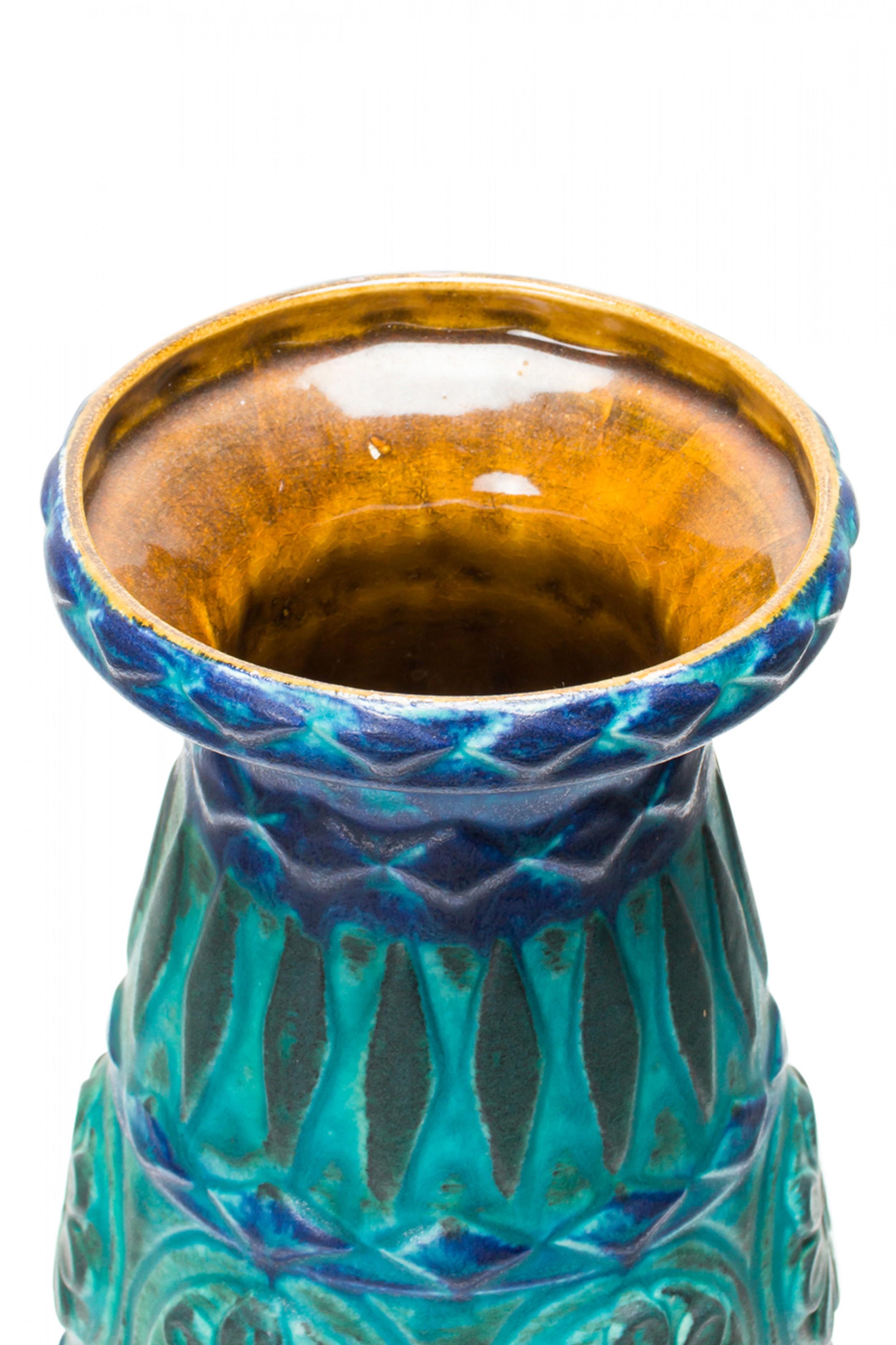 West German mid-century tapered cylindrical form ceramic vase with a wide mouth, a raised banded design of alternating floral medallions and diamonds finished with a multi-tonal green, teal, and blue glaze. (BAY KERAMIK, mark on bottom, BAY W.