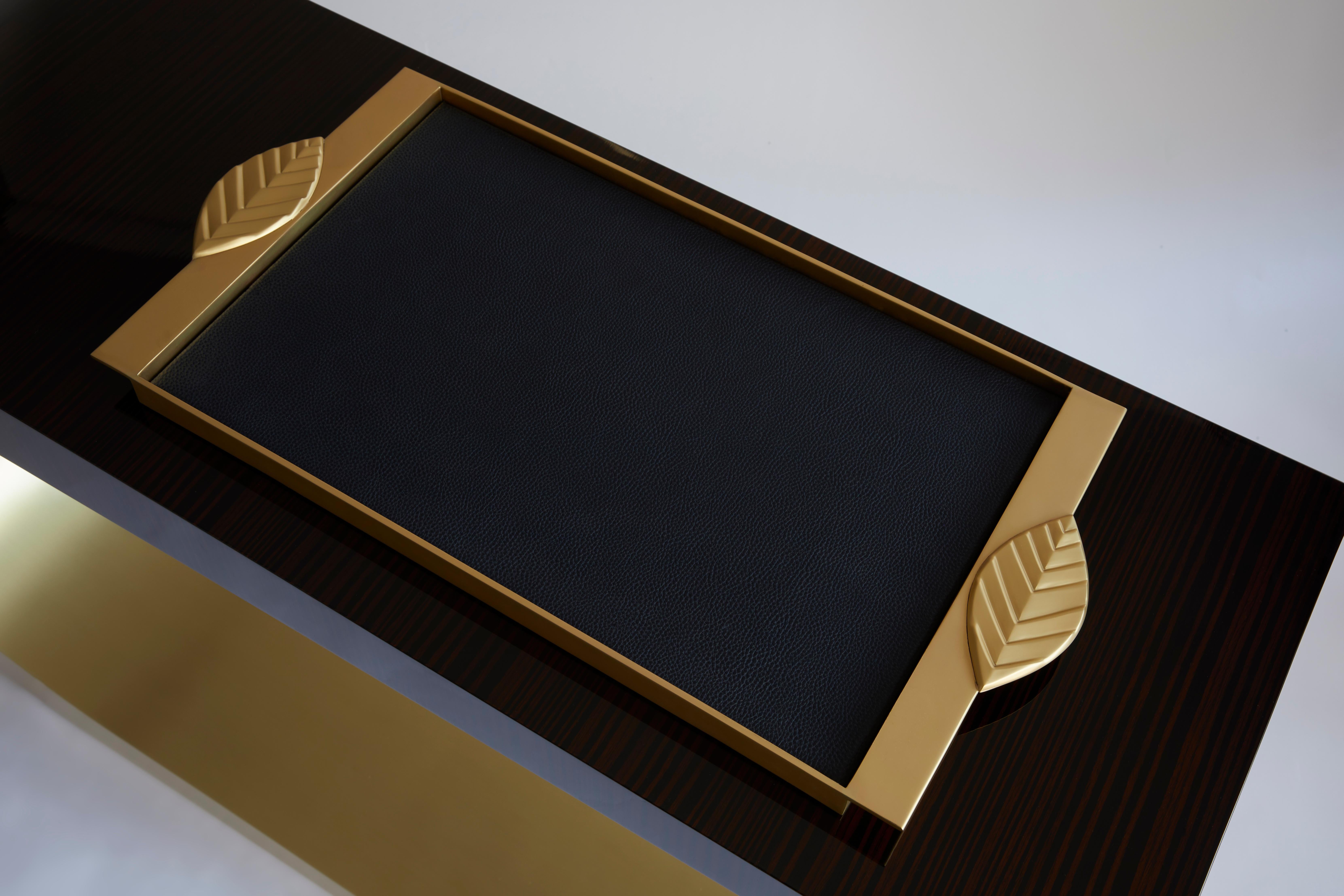 Modern Handcrafted Tray in Solid Brass and Leather by Belbar Studio

Bay Leaf tray in brass with inlay in midnight blue leather. 
Bay leaf handles are cast in brass and are inspired by Pablo Picasso’s origami sculptures. The simple bay leaf was