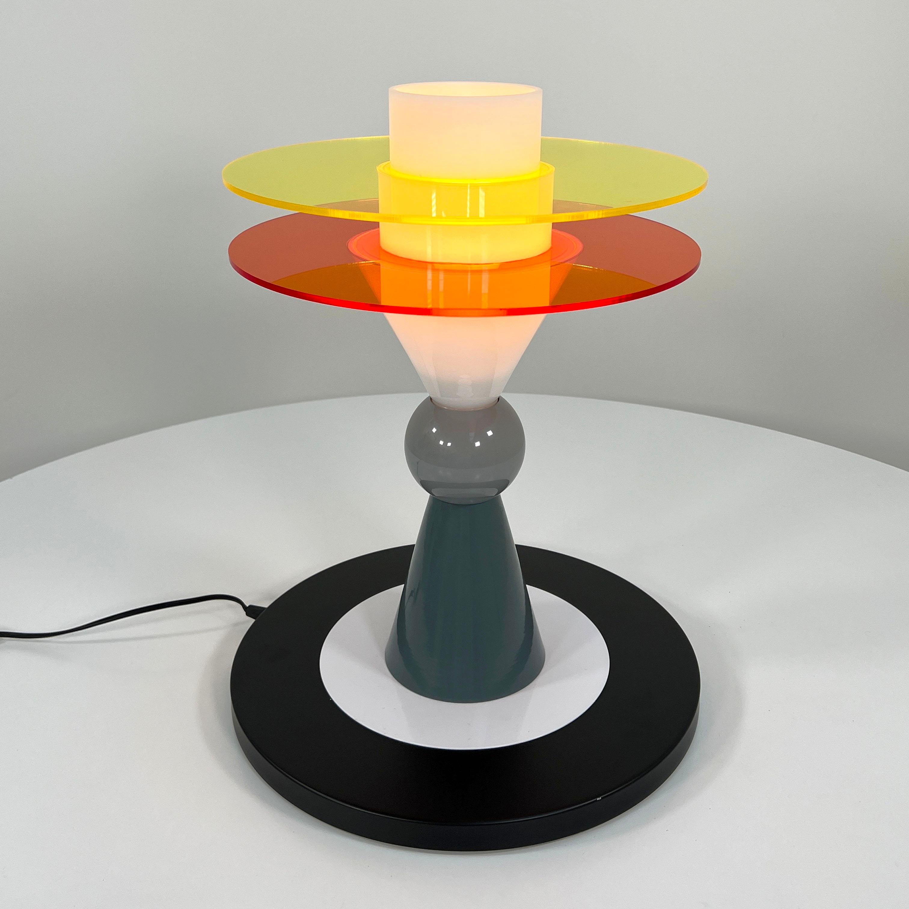 Designer - Ettore Sottsass
Producer - Memphis Milano
Model - Bay Table Lamp
Design Period - Eighties
Measurements - width 40 cm x depth 40 cm x height 53 cm
Materials - Metal, Plastic, Acrylic
Color - black, grey, white, yellow, orange.