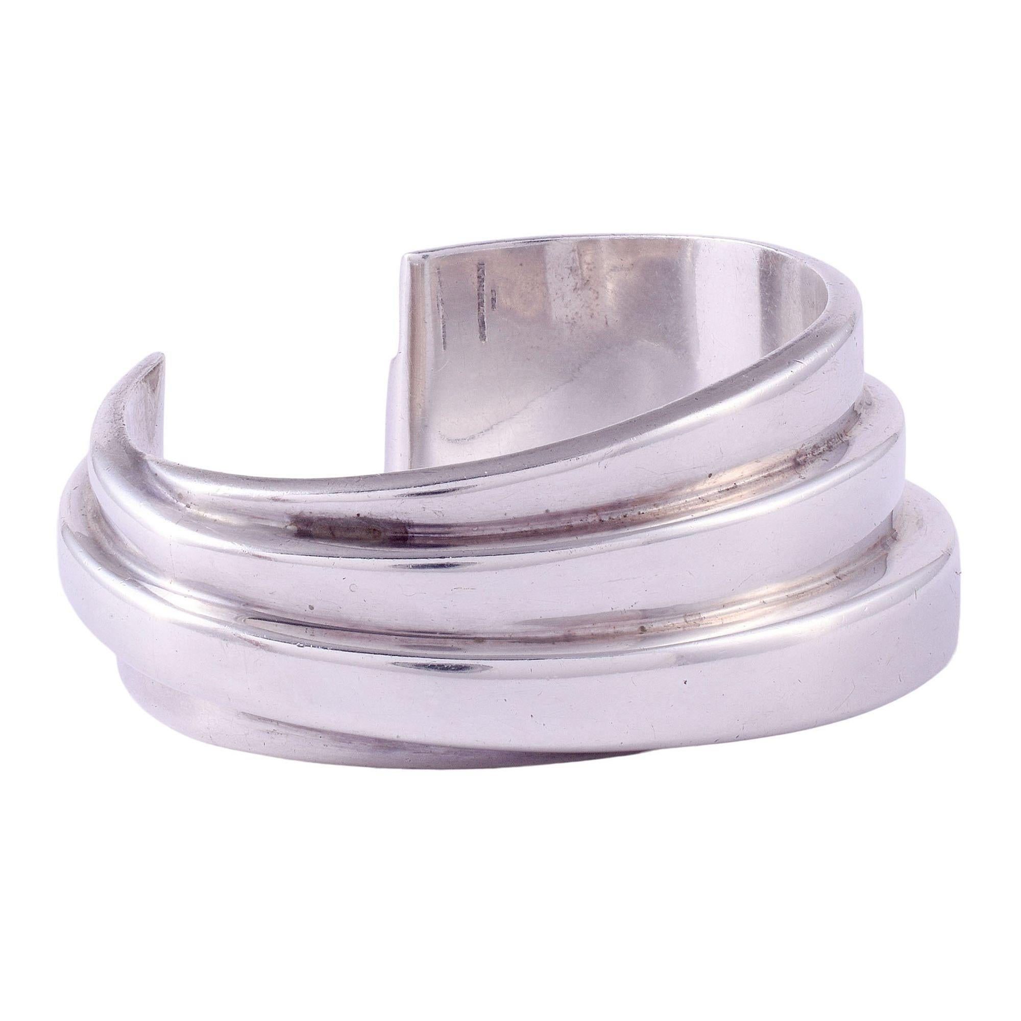 Estate American Bayanihan sterling silver cuff bracelet. This wide cuff bracelet is crafted in sterling silver and signed Bayanihan. The designer cuff bracelet weighs 55 grams. [SJ 1011 P]

Dimensions
2.5