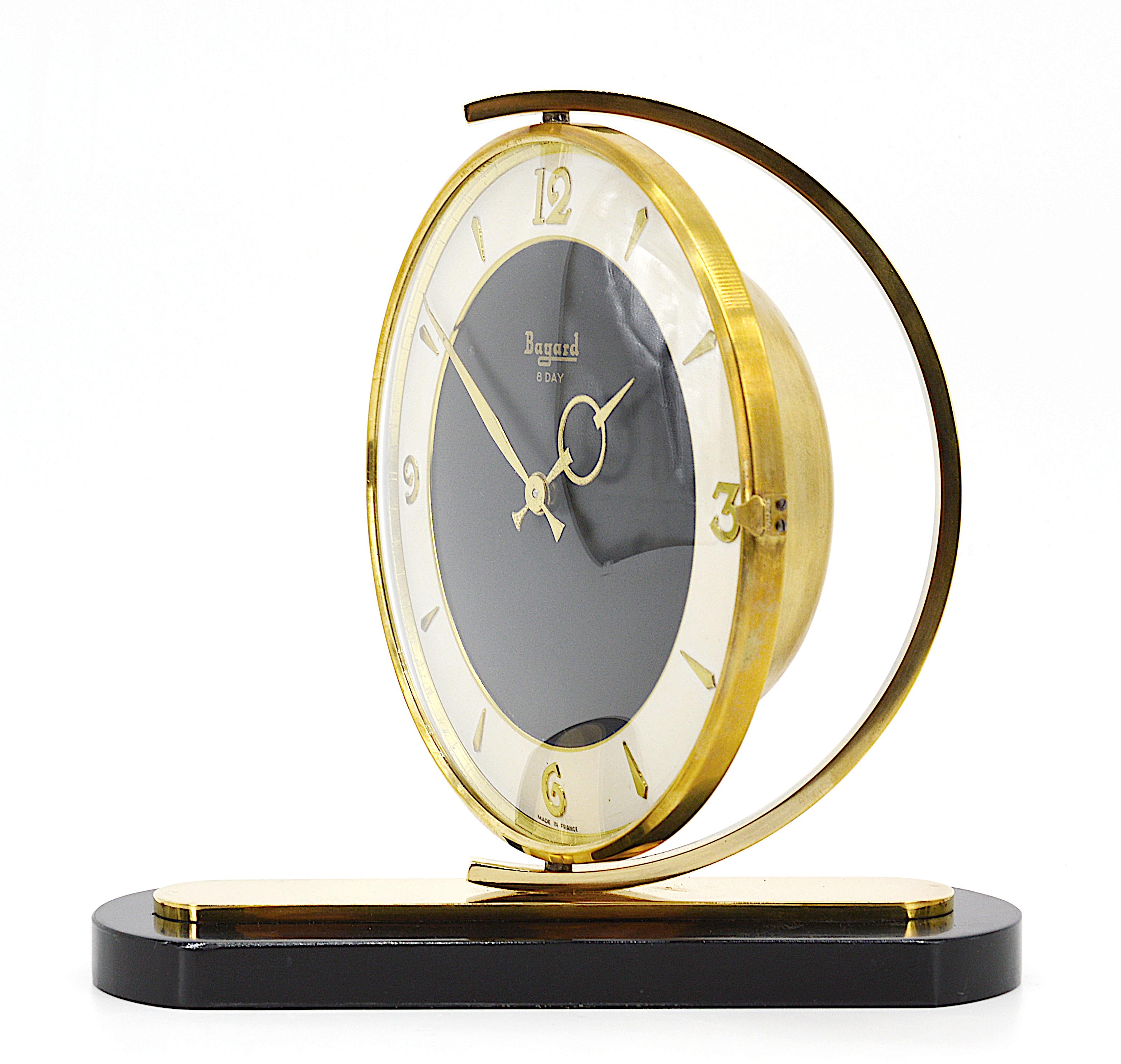 French Art Deco clock by Bayard, France, 1930s. Swivel brass black dial. Marble base. Rounded glass. 8 days movement. Measures: height 7.5
