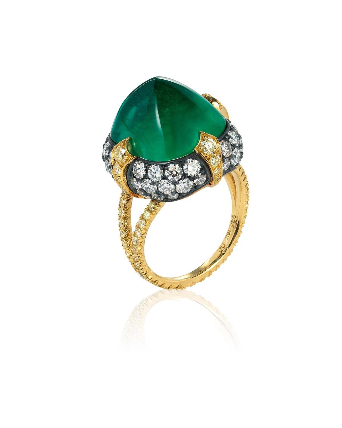 A unique 18kt yellow gold and oxidized silver ring centered upon a superb 11.28 carat sugarloaf Colombian emerald, certified by AGL and C.Dunaigre, set atop a pillow of pavé colorless diamonds and held in place by four 18kt yellow gold
