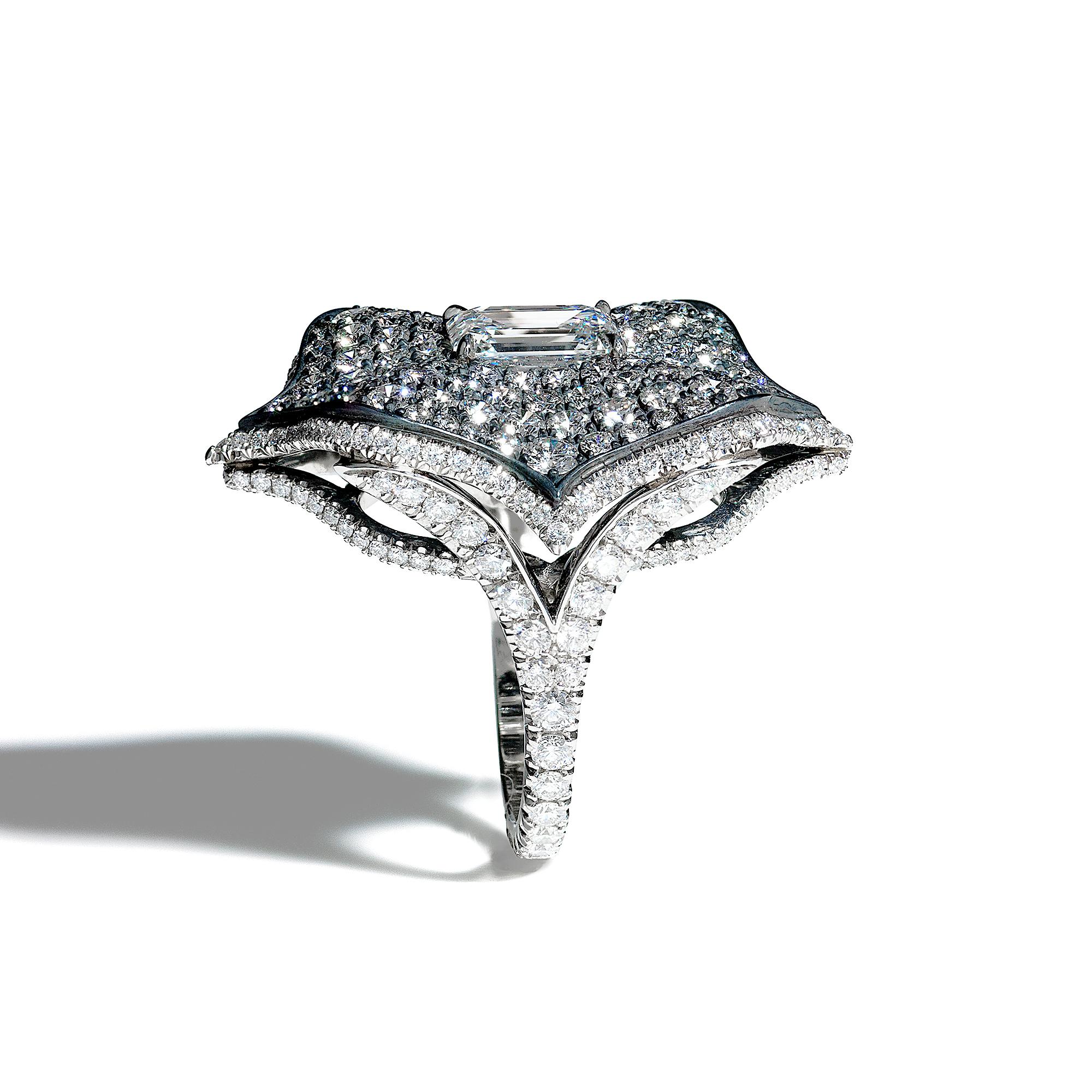 A beautiful Lotus ring centered upon a 1.85 carat G color VS2 clarity emerald-cut diamond, certified by GIA, set atop a bed of diamond pavé set in oxidized silver which is surrounded by a platinum frame set in diamond micropavé with diamond