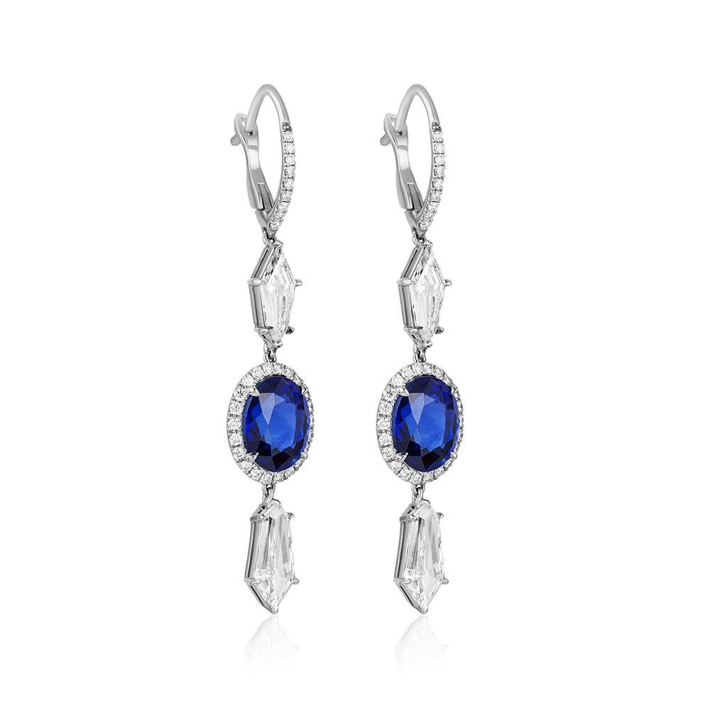 A pair of platinum ear-pendants centered upon a perfectly matched pair of natural unheated oval Madagascar sapphires weighing 6.34 carats total weight, accompanied by C. Dunaigre Consulting lab report, set within a diamond micropavé surround