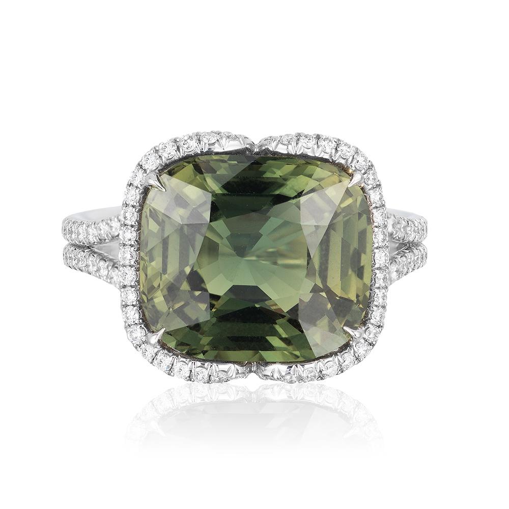 A platinum ring centered upon a gem quality 6.92 carat cushion-cut natural unheated Madagascar green sapphire, certified by GIA and C.Dunaigre Consulting, set in an intricate diamond micropavé design with 165 white diamonds weighing 0.55 carats