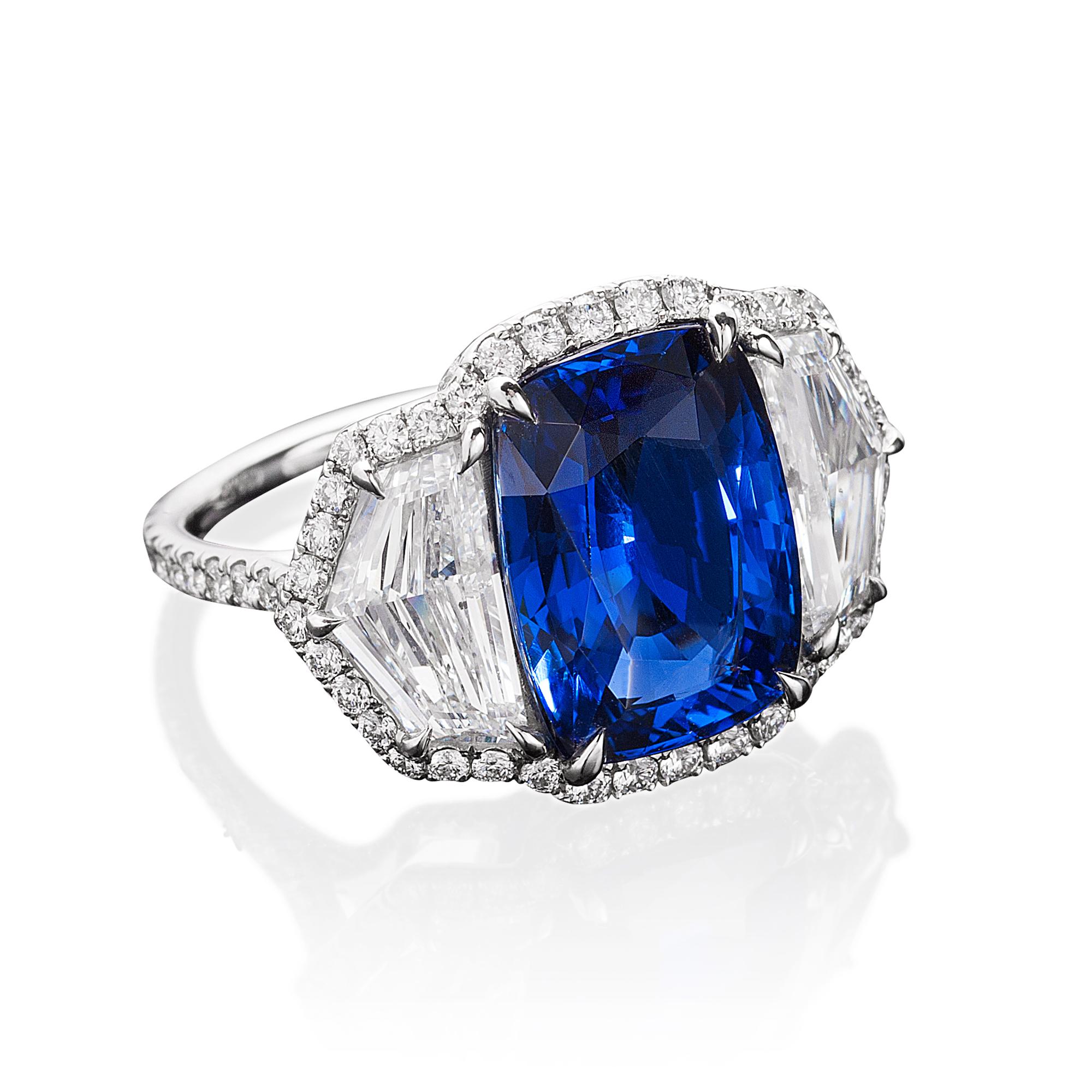 A platinum ring centered upon a rare 7.60 carat natural unheated cushion Burma sapphire, certified by GIA and C.Dunaigre, flanked by epaulet diamonds all set within a delicate diamond micropavé surround with diamond micropavé on the underwire and