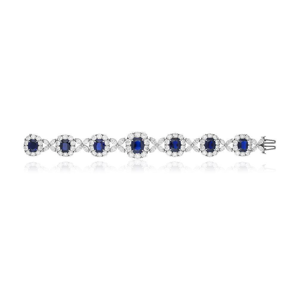 A unique platinum bracelet set with 7 perfectly matched natural unheated cushion-cut  Burma sapphires weighing 26.40 carats total, certified by  AGL and C. Dunaigre, each set within a round colorless diamond surround and separated by marquise