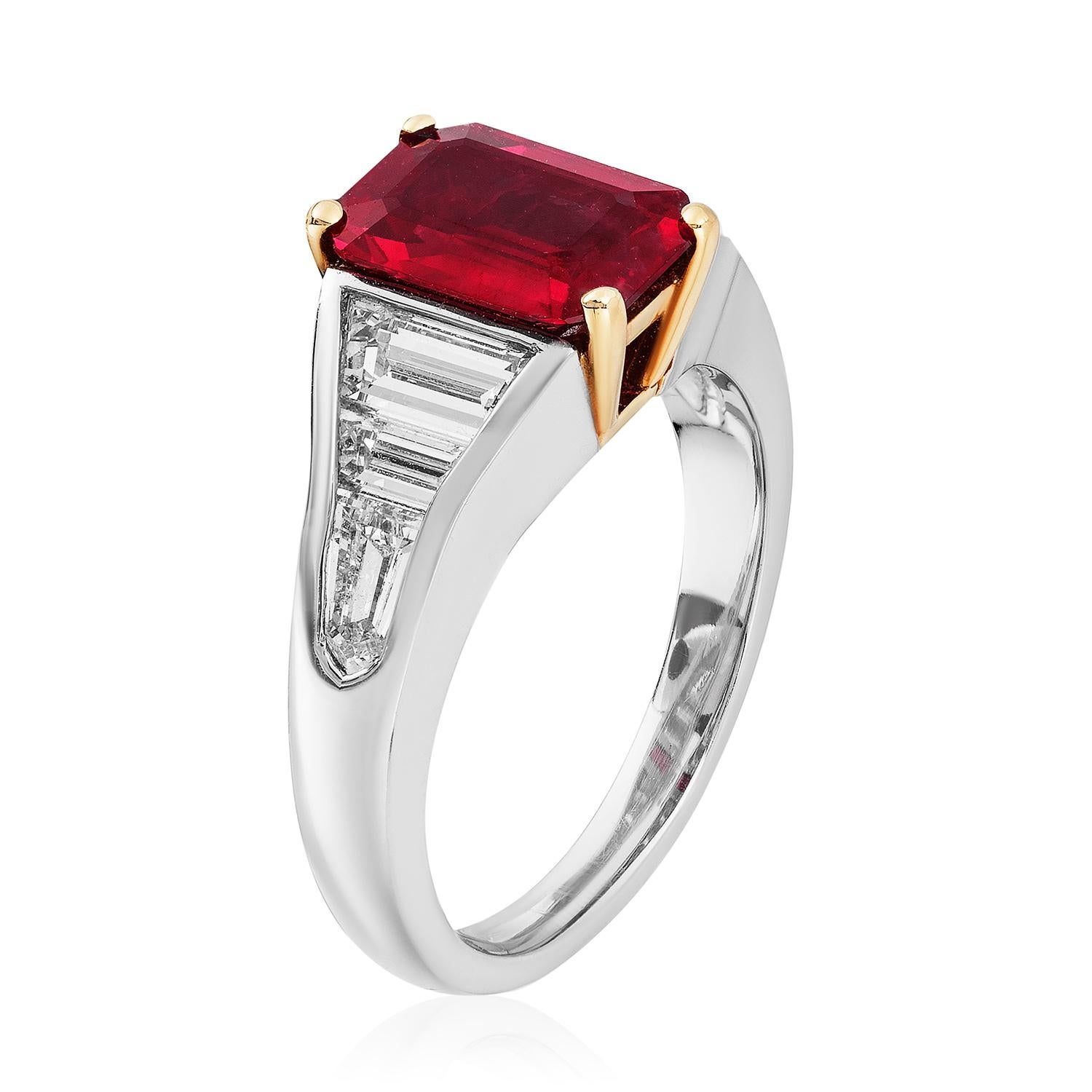 A platinum & 18kt yellow gold ring centered upon a beautiful 2.10 carat emerald-cut Burma ruby, certified by GRS, set with two trapezoid colorless diamonds and a bullet colorless diamond in each shank. 

Fashions may fade, but classic jewelry always