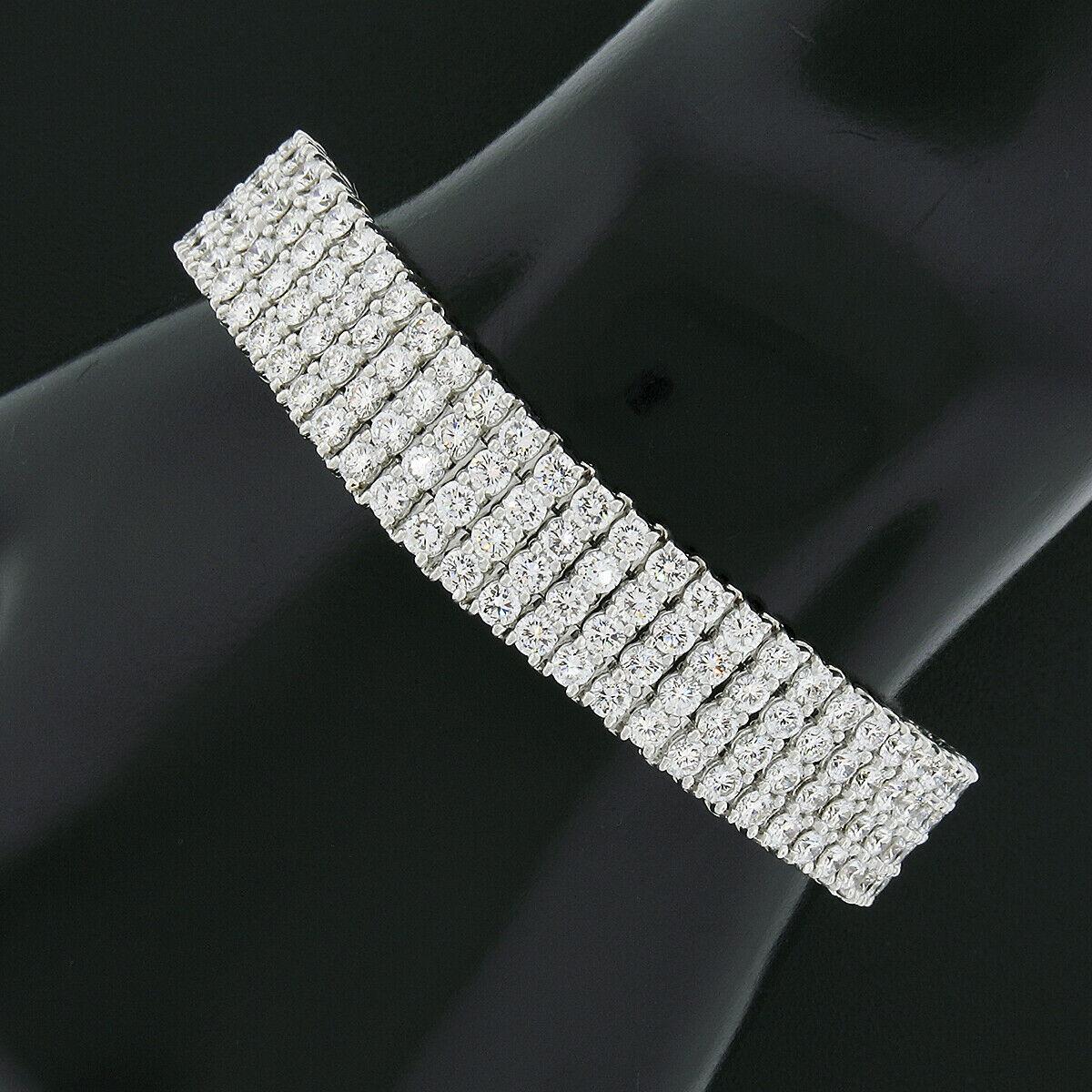 Here we have an absolutely magnificent diamond strap tennis bracelet that was very well crafted from solid .950 platinum. This wide bracelet features 4 rows of very fine quality round brilliant cut diamonds in which are neatly shared-prong set