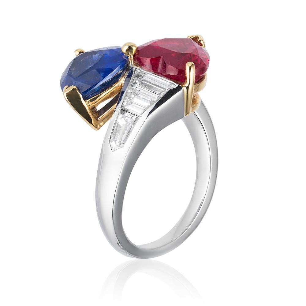 A platinum & 18kt yellow gold ring centered upon a 3.02 carat heart-shaped Mozambique ruby and a 2.81 carat heart-shaped Ceylon sapphire, certified by C. Dunaigre Consulting, set with 6 colorless diamonds weighing 1.26 carats total.

Fashions may