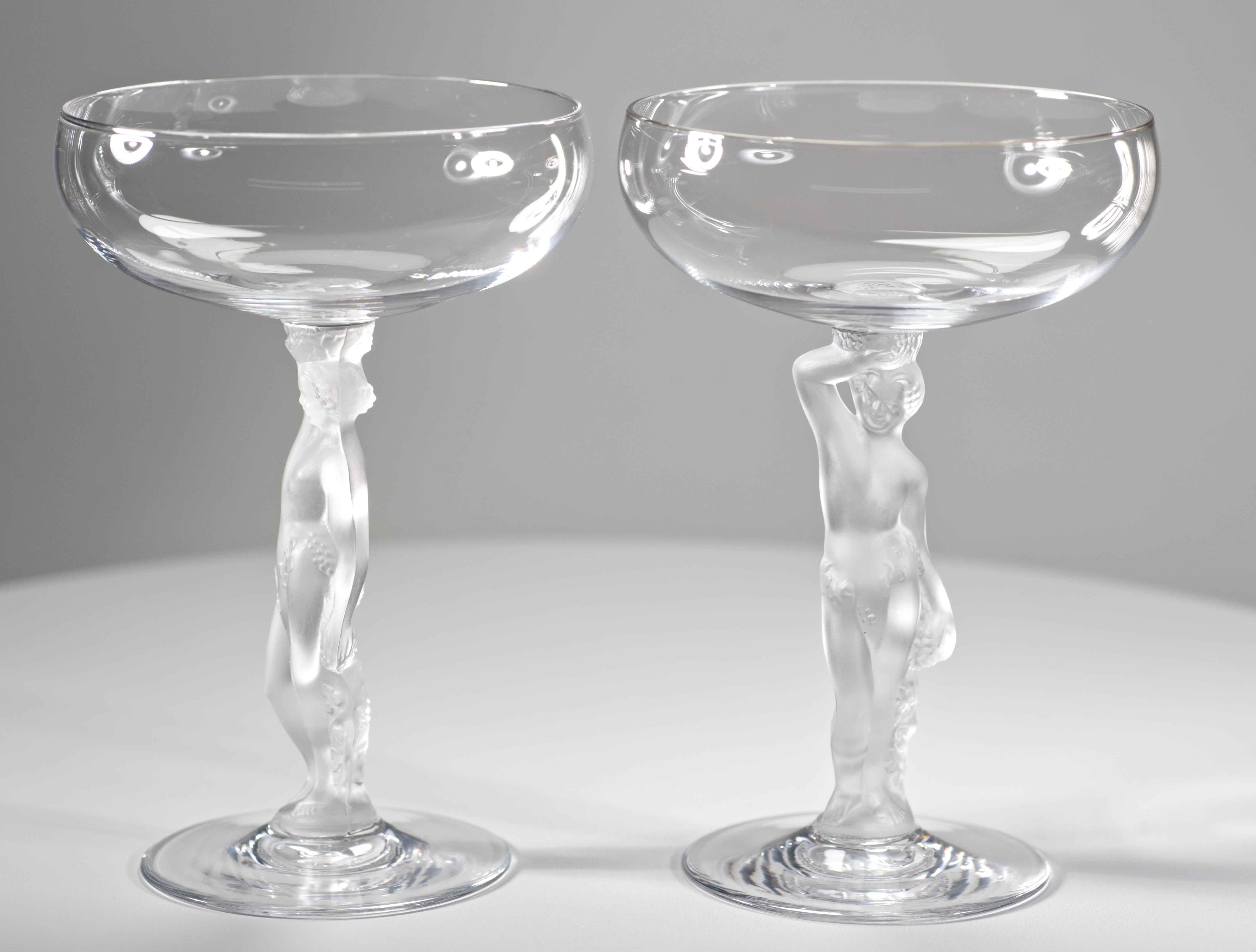 Vintage, Art Deco style champagne coupe glasses feature frosted stems depicting the nude figure of Bacchus, the god of wine. The series was made circa 1976-1981.

The glasses are in good vintage condition; they will be a stunning addition to any