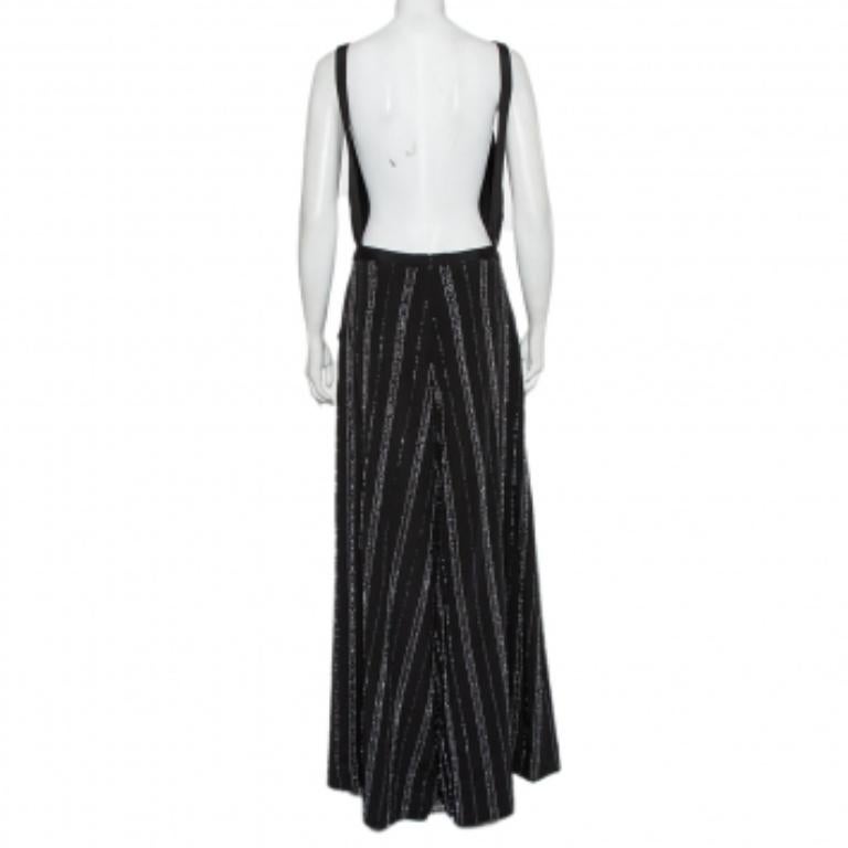 Bazza Alzouman's black jumpsuit is the perfect alternative to an evening dress. It is covered in sequin embellishments with an open back, while the bottoms are cut in a wide-leg silhouette. All you need is a pair of glamorous sandals and a clutch to