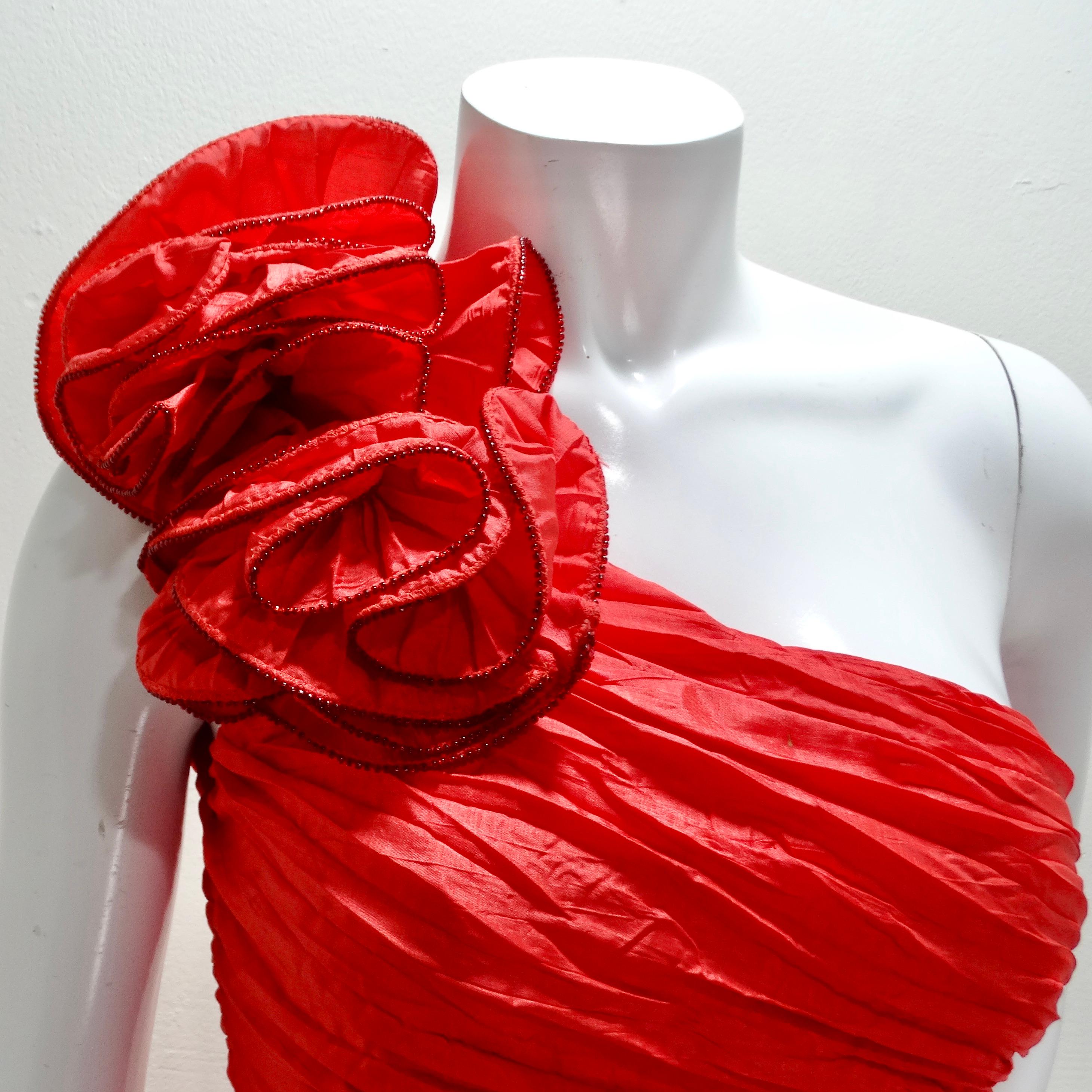 Voici la robe à motifs de roses asymétriques rouge des années 1980 de BB Collections, une expression étonnante d'élégance audacieuse et de charme enjoué. Cette robe mi-longue séduit par sa teinte rouge vibrante et ses détails de conception uniques,