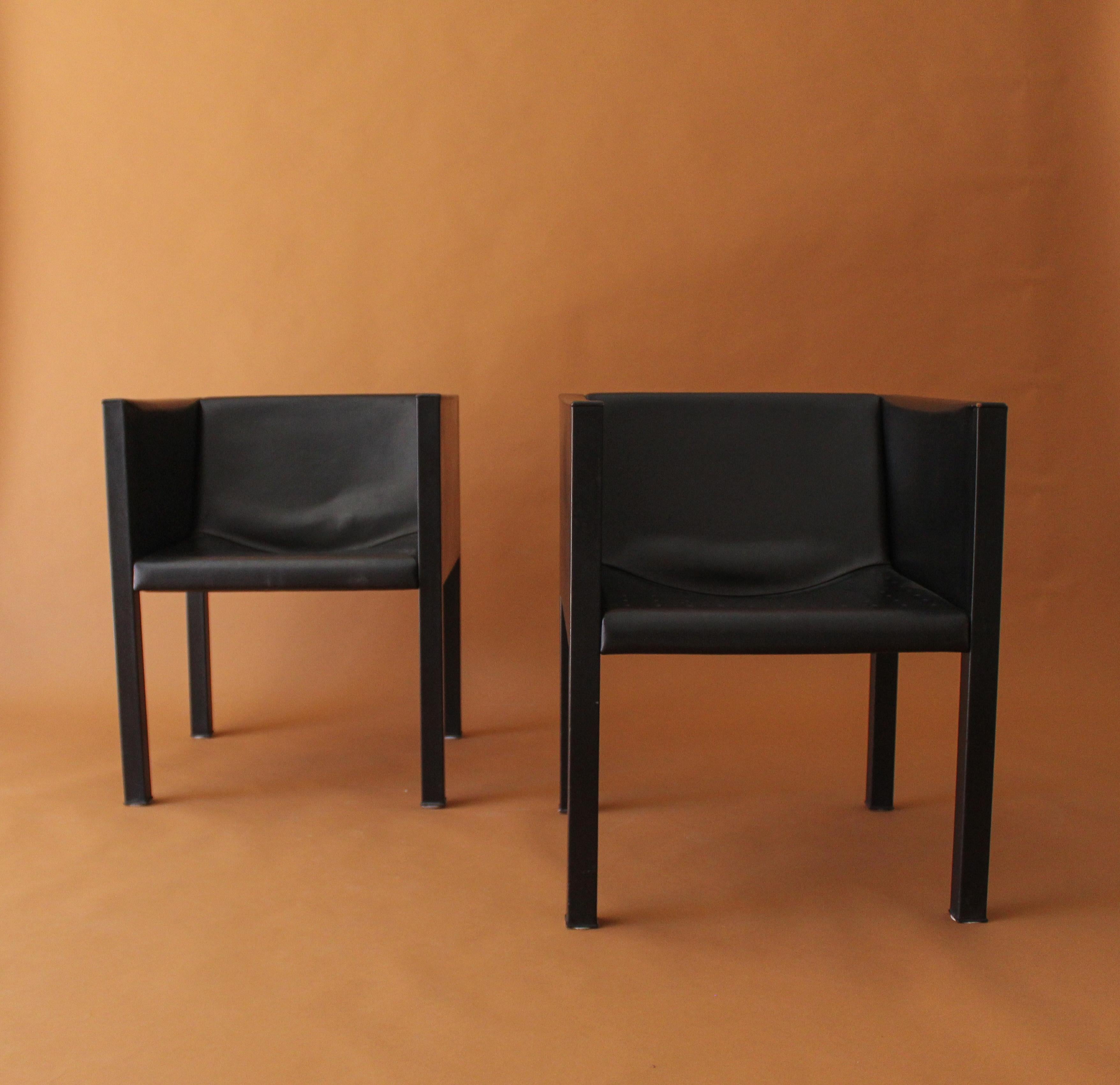 Pair of unusual B&B Italia chairs fully covered in thick black leather, we have contacted several B&B Italia showrooms and they have been unable to identify the maker. We have found some attribution in Auction catalogs to Mario Bellini but unable to