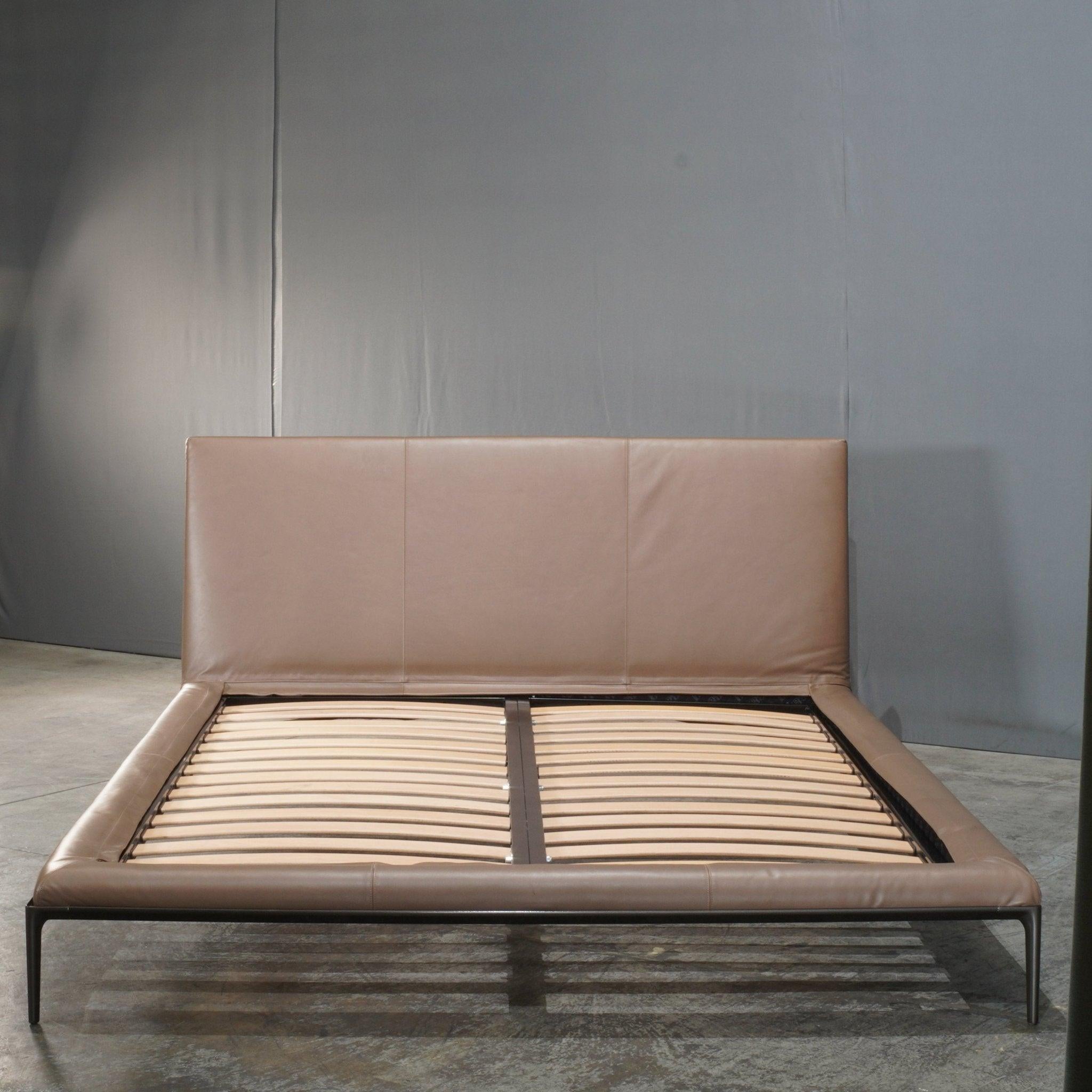 The B&B Italia Atoll Queen Bed combines modern elegance with unparalleled comfort. Designed with a minimalist aesthetic, this bed features a sleek, upholstered headboard and frame, seamlessly blending into any contemporary bedroom. The headboard's