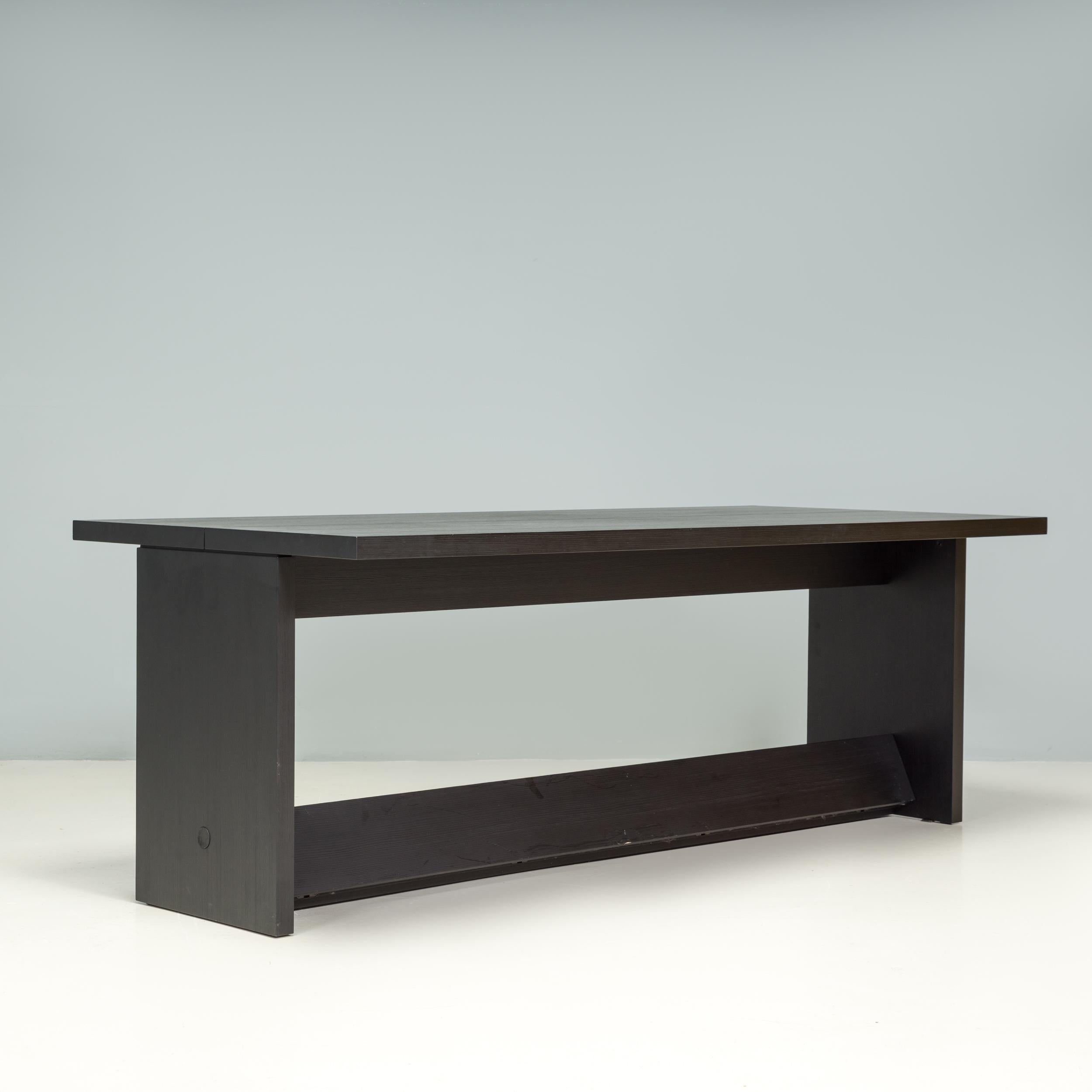 Originally designed by Antonio Citterio for B&B Italia the Argo dining table has a sleek structural groove diving the top. 

A fantastic example of contemporary Italian design, the dining table is constructed entirely from solid brushed black oak