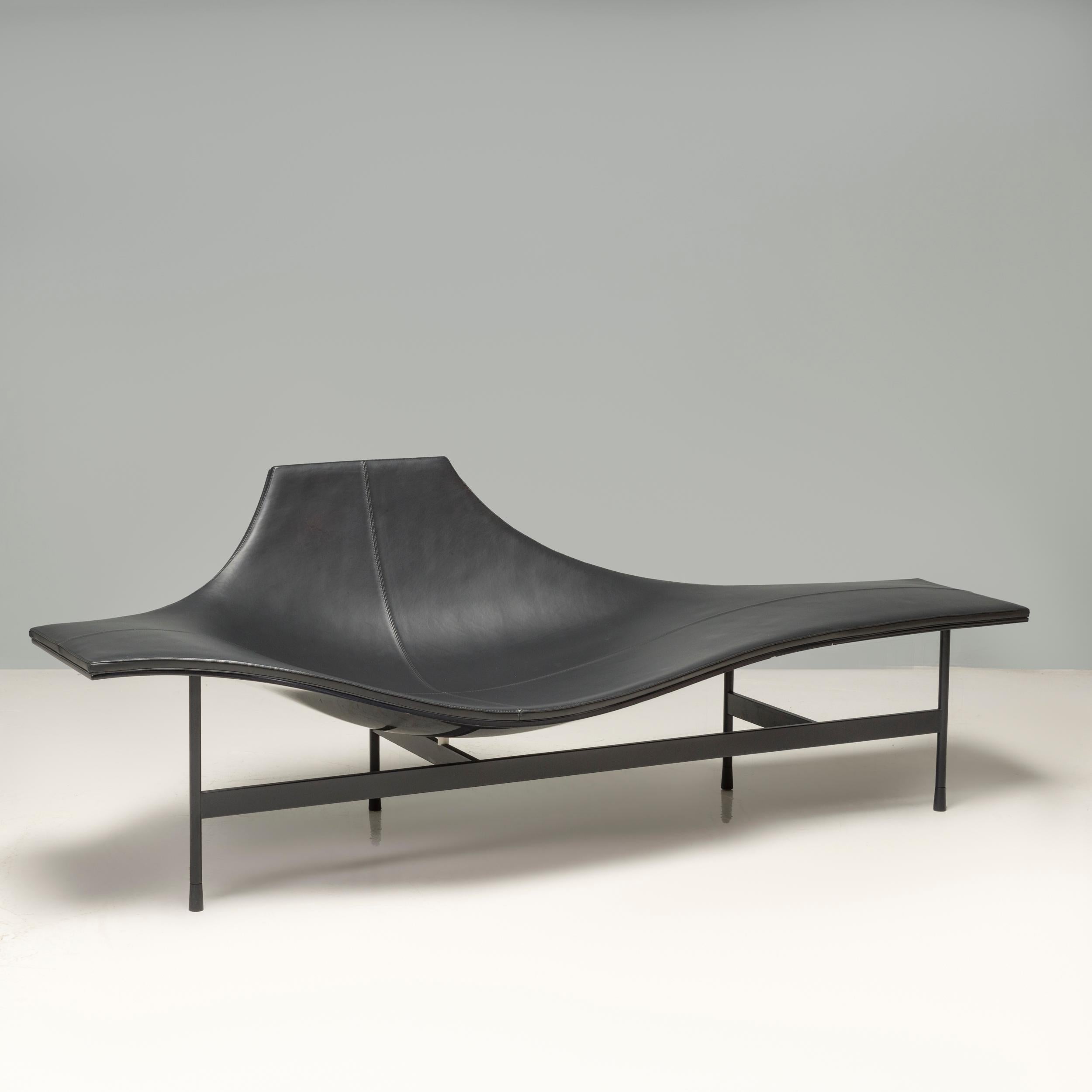 This black chaise lounge was created in 2008 by French architect, inventor and designer Jean-Marie Massaud. The flowing lines of the seat contrasts strikingly with the linear, structural metal base, as do the glossy and matt finishes. With its dual