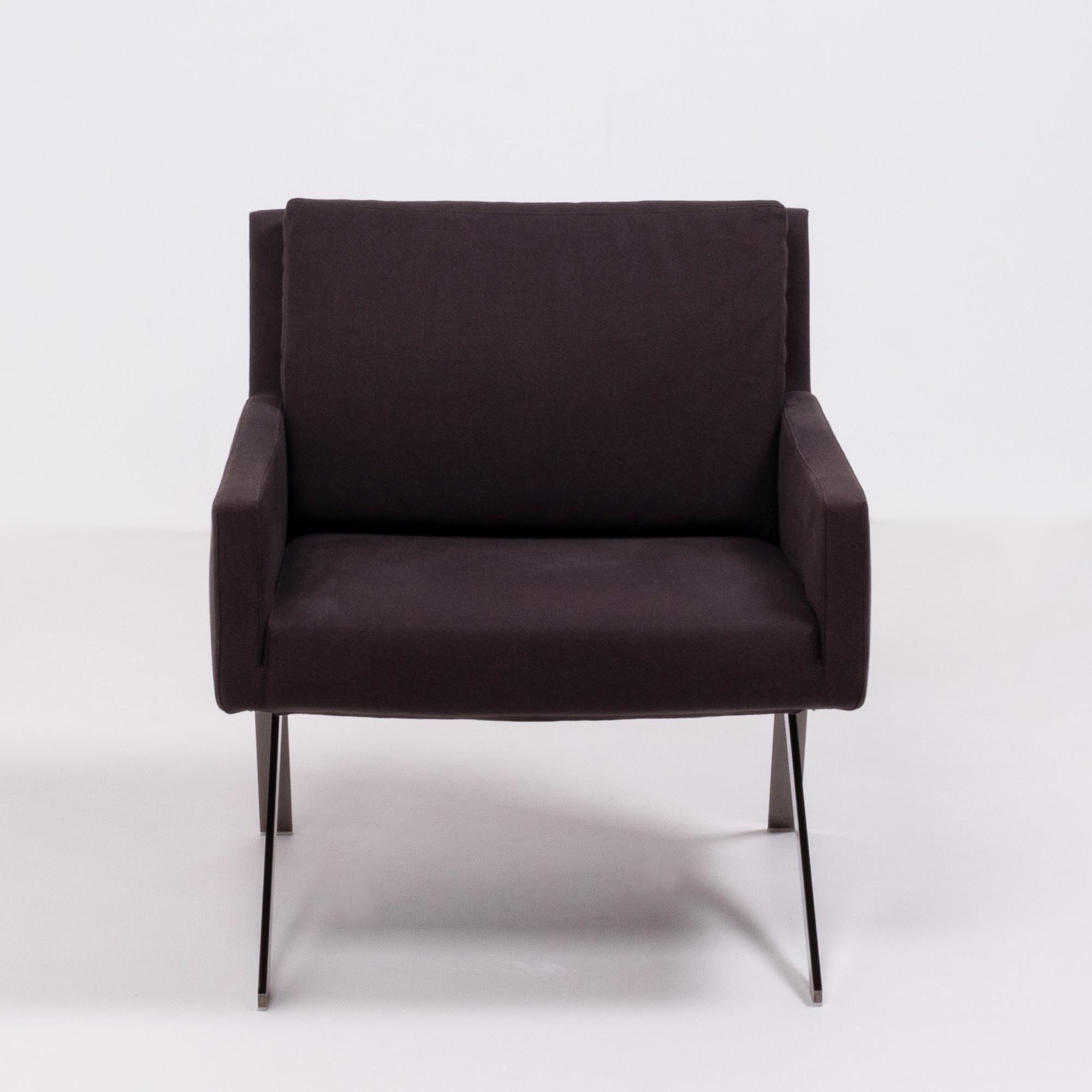 Designed by Vincent Van Duysen for B&B Italia, the Theo armchair has a sleek, modern Silhouette.
Featuring a tubular steel frame, the chair has angular steel legs and side panel detailing, while the seat is upholstered in chocolate brown fabric.
A