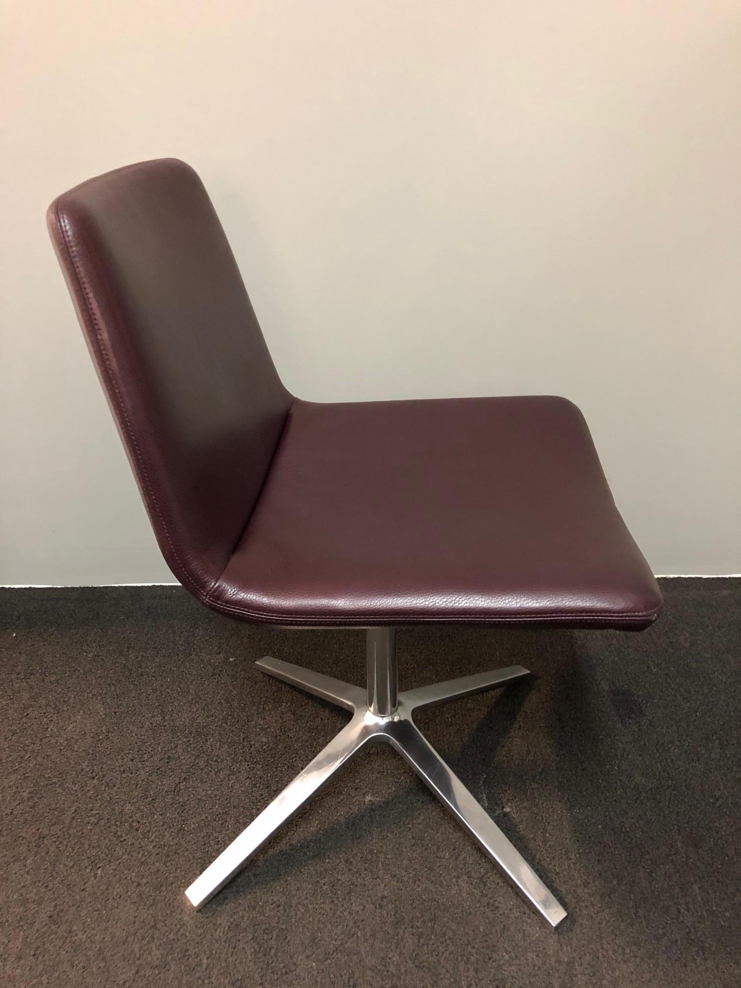 This is an evolution of the metropolitan chair. The renewed frames range from the more classic four bright brushed aluminium spokes with swivel seat. The frame has some scratched due to use of the chair. The burgundy leather is stunning.