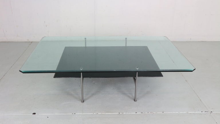 1 st edition Two tier ‘Diesis’ coffee table designed by Antonio Citterio and Paolo Nava for B&B Italia, 1970's Italy.
The upper tier is made of solid Glass and the lower tier is made of thick black leather. The frame is made of solid
