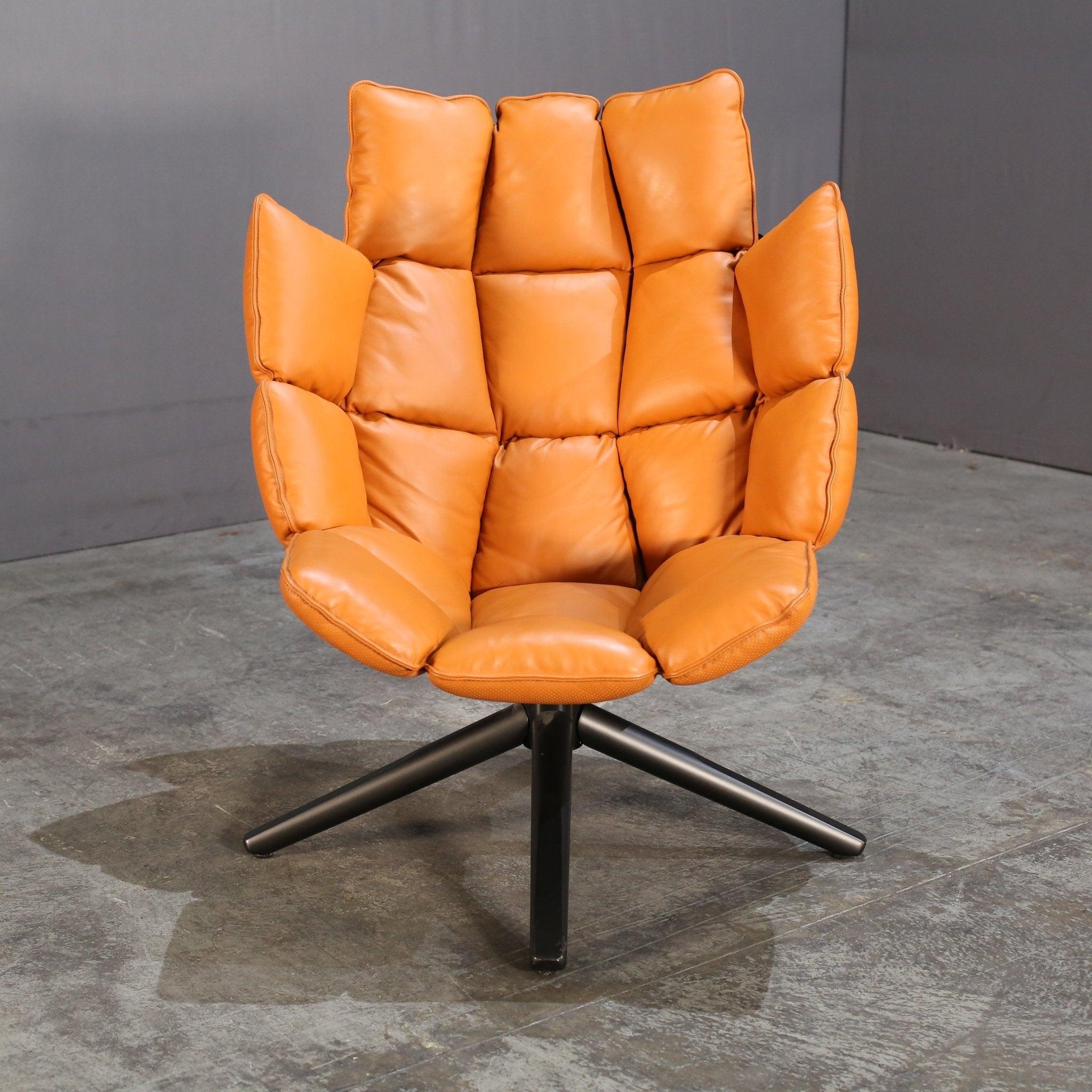 Introducing the B&B Italia Husk Swivel Chair, designed by renowned designer Patricia Urquiola. This luxurious chair features a unique shell-shaped backrest, providing both comfort and style. The swivel base allows for easy movement, making it a