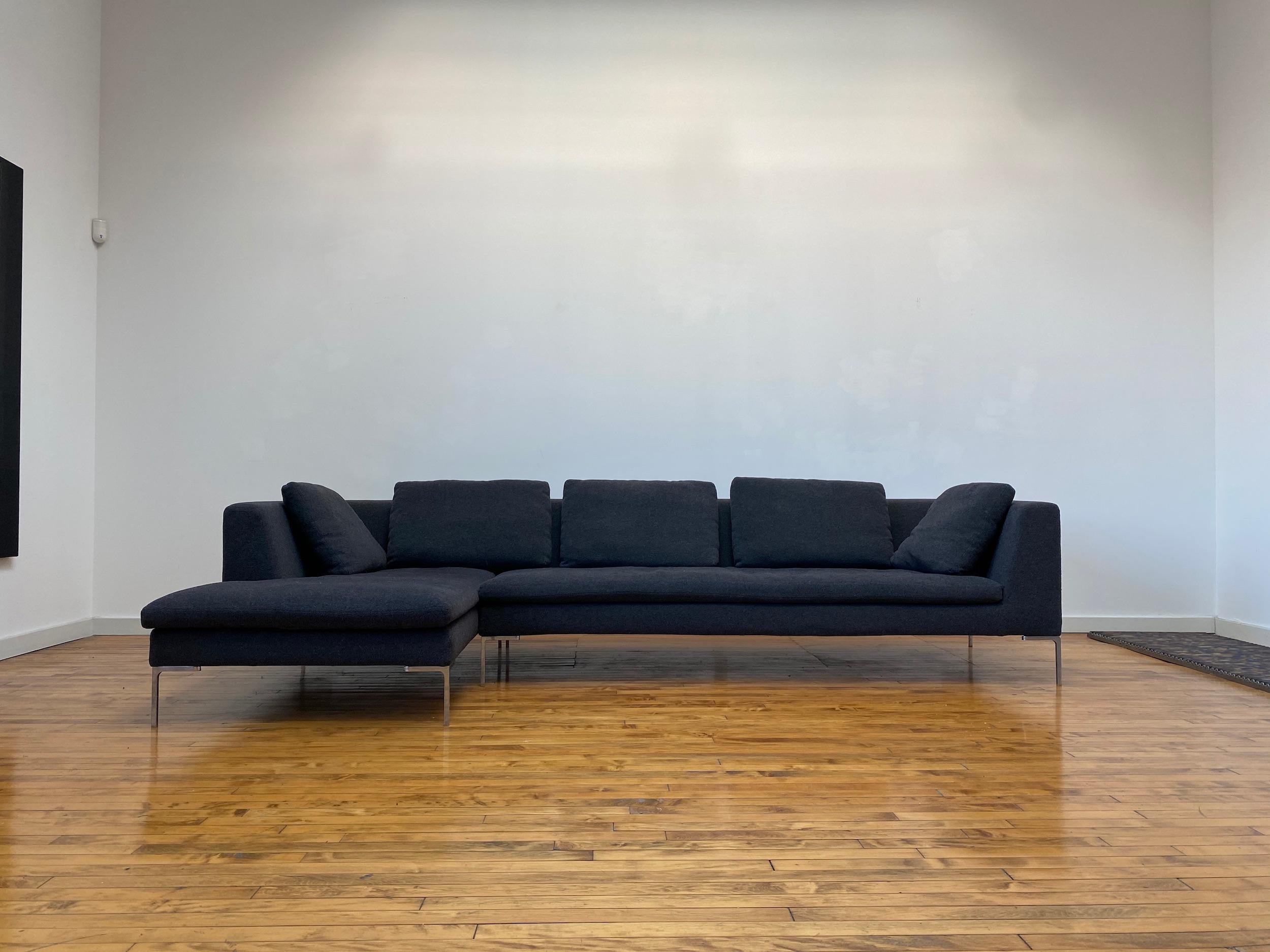Elegant B&B Italia Charles sofa by Antonio Citterio. This sofa consists of two sections, one straight and one chaise to form a sectional. Sits on die-cast aluminum L-shaped feet. It is famous for its airy and simple profile. Dark Grey Aramis 155