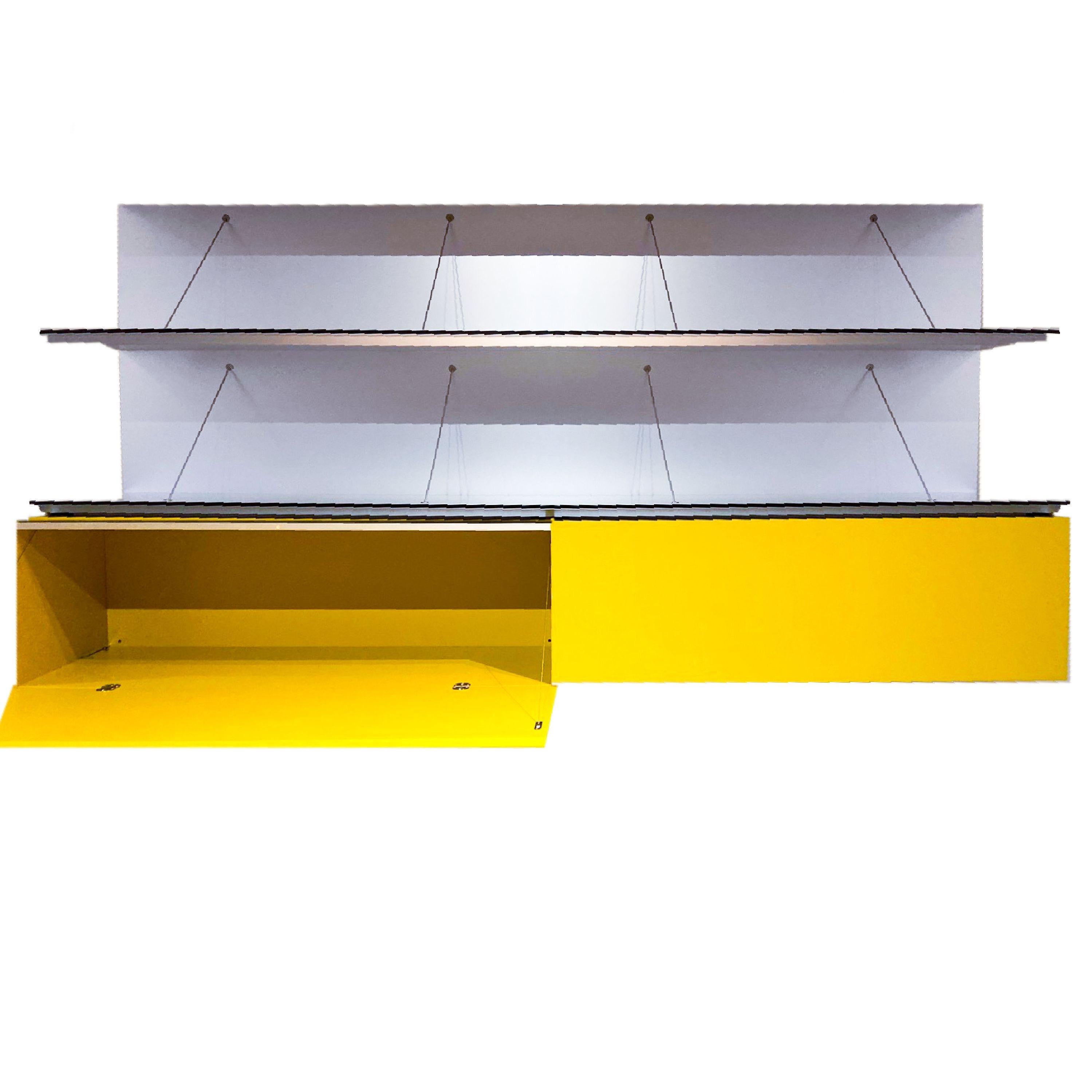 Pab Wallsystem by Studio Kairos for B&B Italia in custom citron lacquer shelves & cabinet

It is the result of a very simple idea: a sheet folded in half and restrained by light ties, designed to be used as a bookshelf and top. In time, Pab has