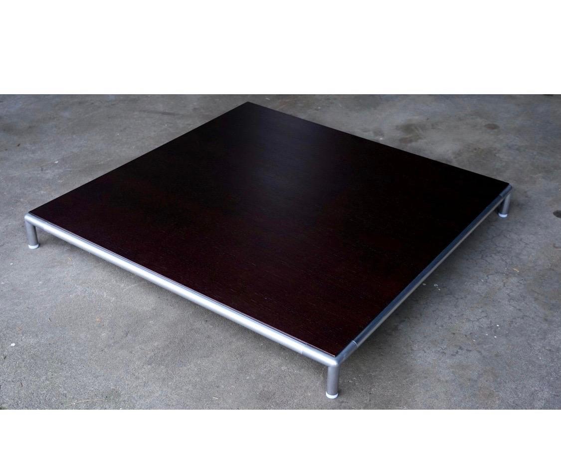 Midcentury B&B Italia 'George' rosewood coffee table by Antonio Citterio. Beautiful rosewood tabletop with tubular aluminum frame that wraps around entire table. Low profile design with large surface, that helps create a spacious environment.