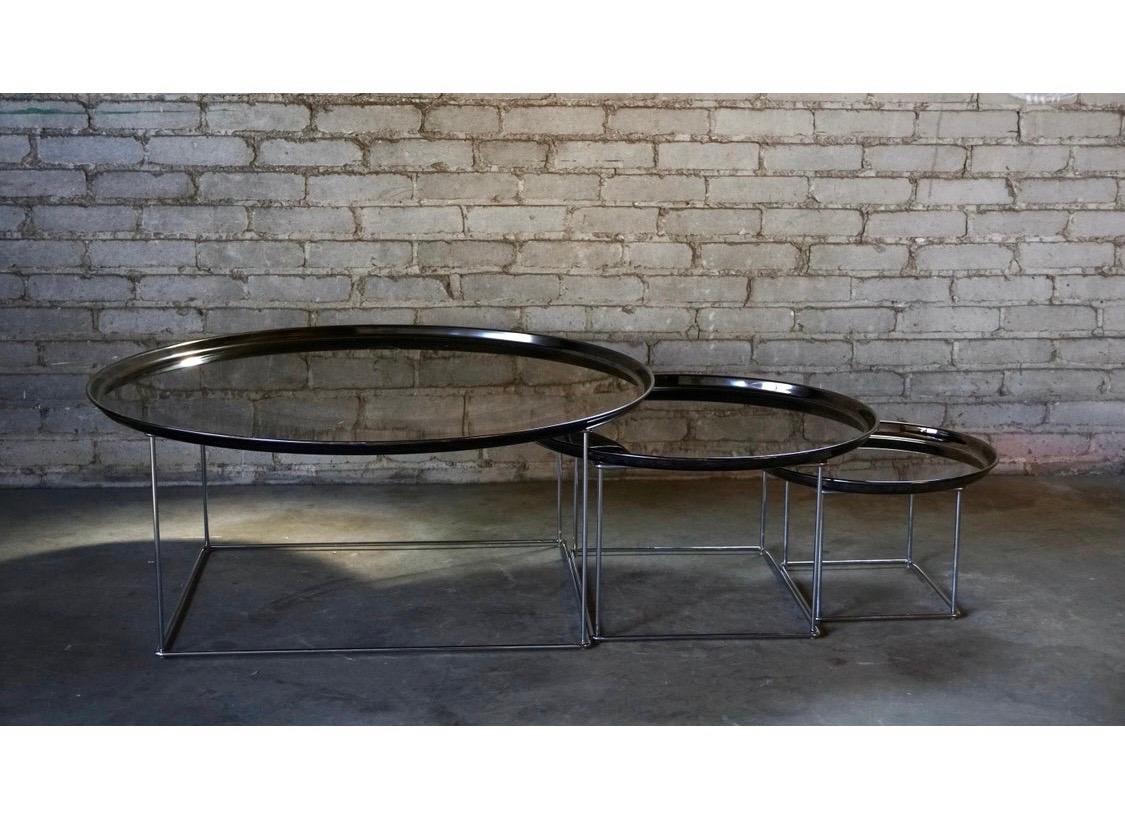 Made in Italy by B&B Italia and designed by esteemed Patricia Urquiola, is the set of three Fat-Fat
nesting tables. Part of B&B's Maxalto line from 2005. Round smoked black chrome metallic tops that have some age appropriate wear and rubber feet